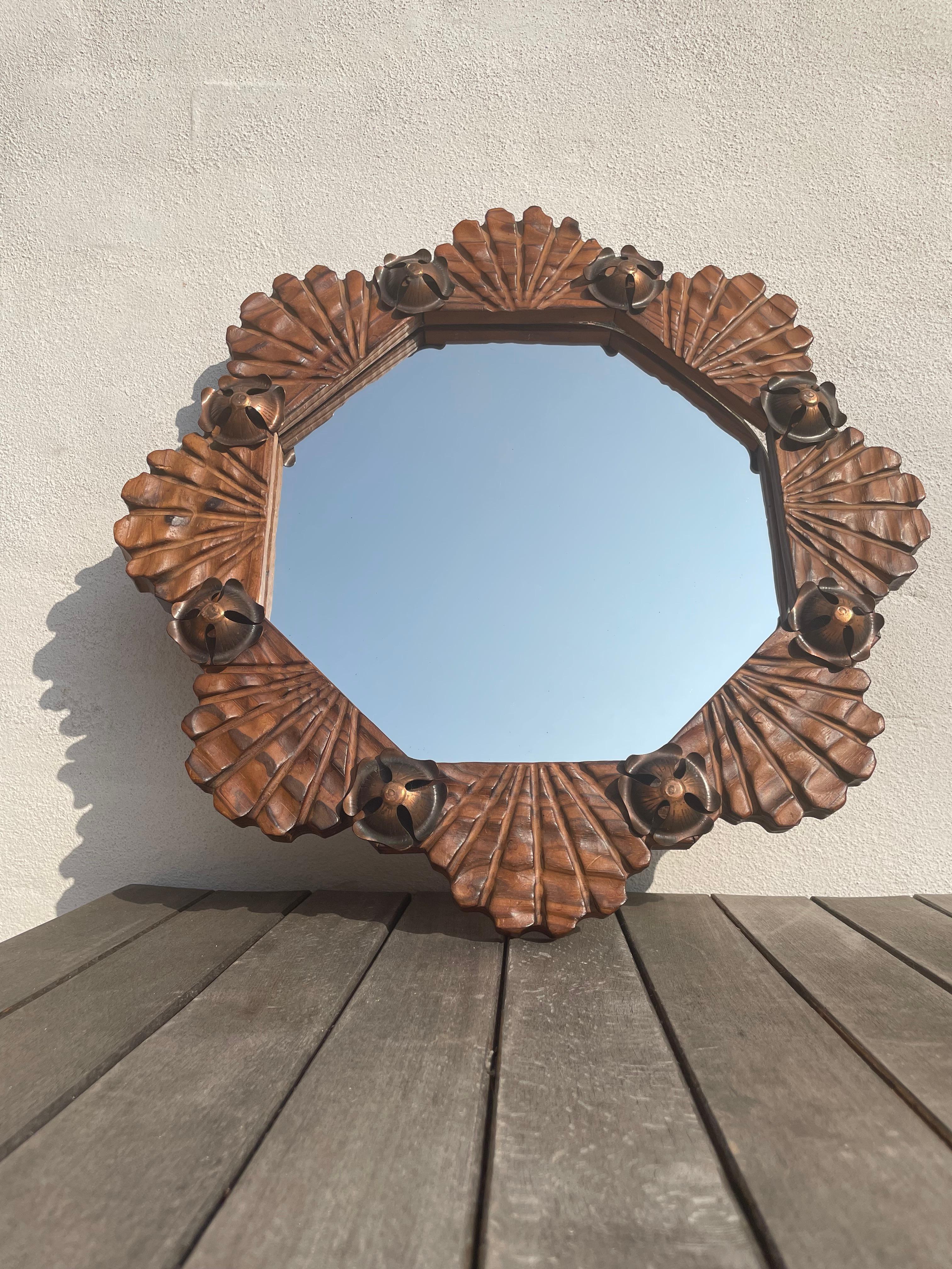 Early 1970s Spanish midcentury modern brutalist lacquered wooden wall mirror with brass floral decor and hand-carved organic lined structure and textured appearance. Date stamped on mirror and original label on back. Beautiful vintage condition.