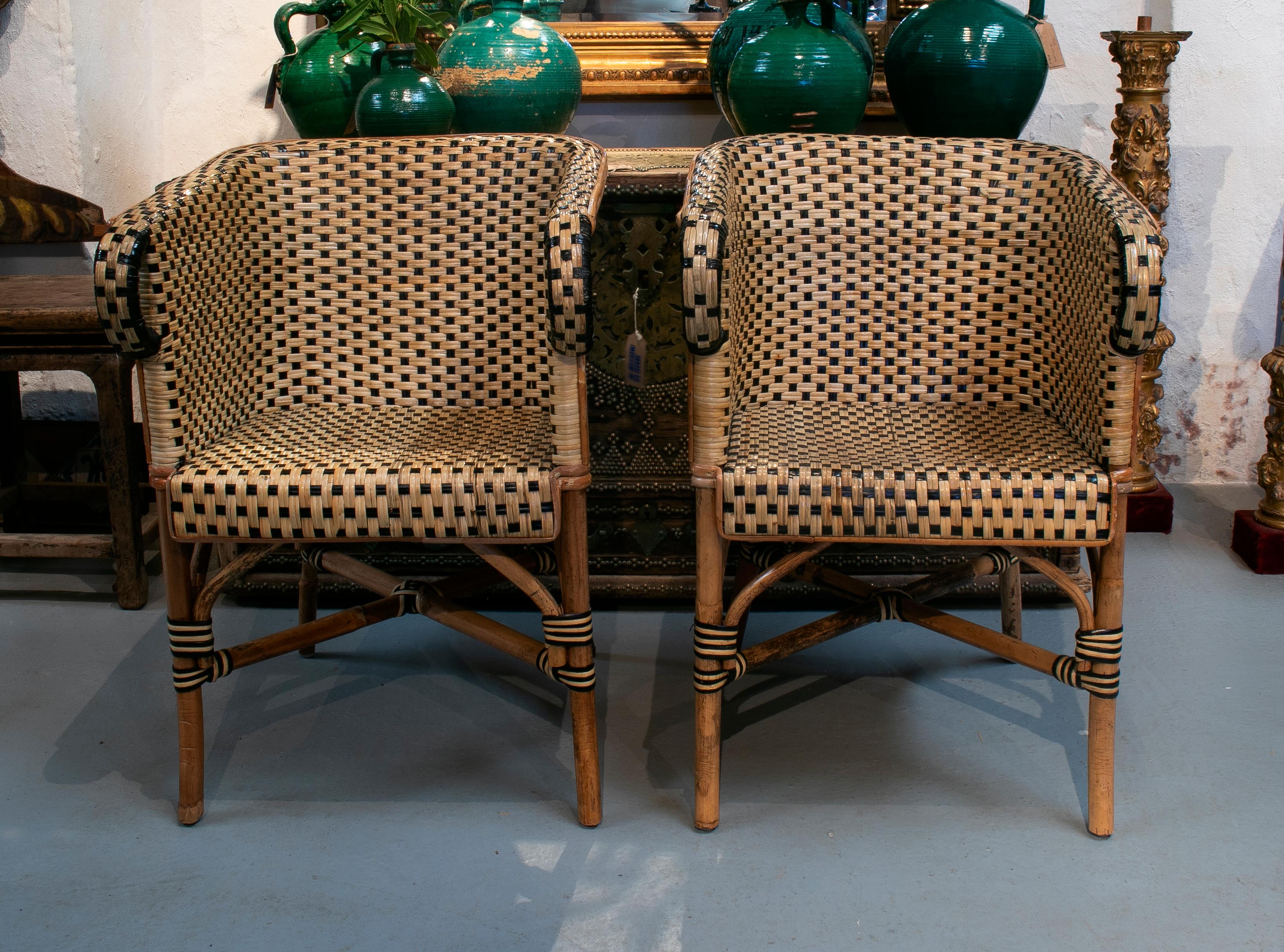 1970s Spanish pair of bamboo and wicker armchairs.