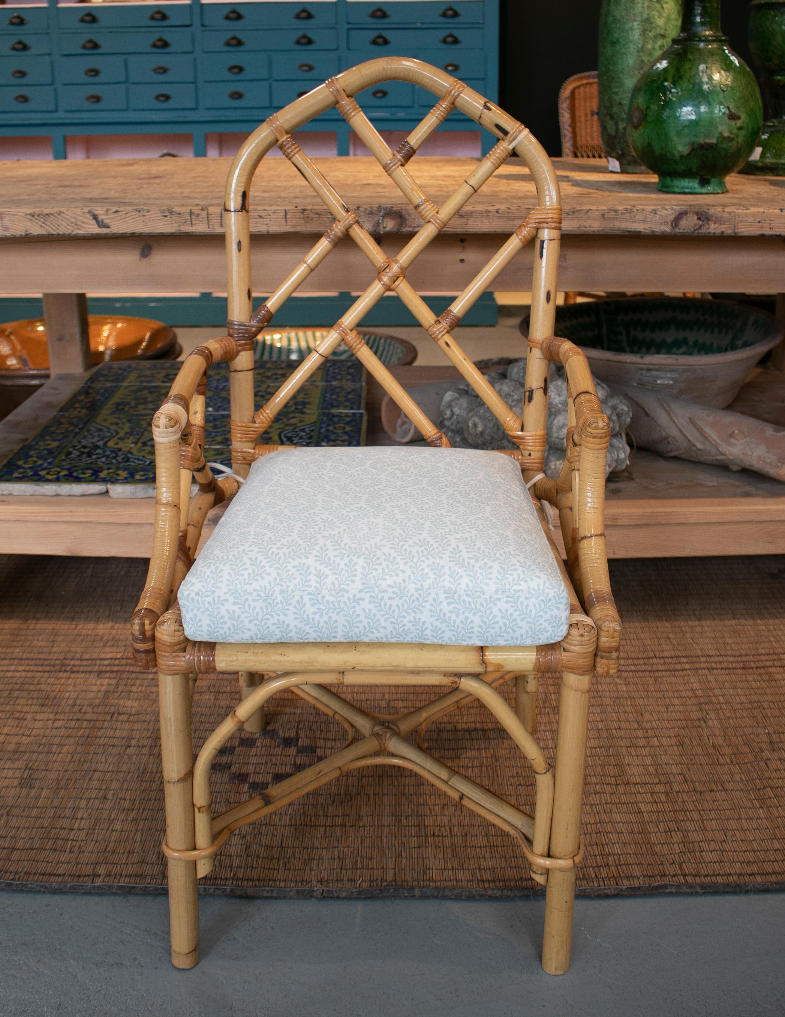 Vintage 1970s Spanish pair of bamboo chairs with white seat cushions.