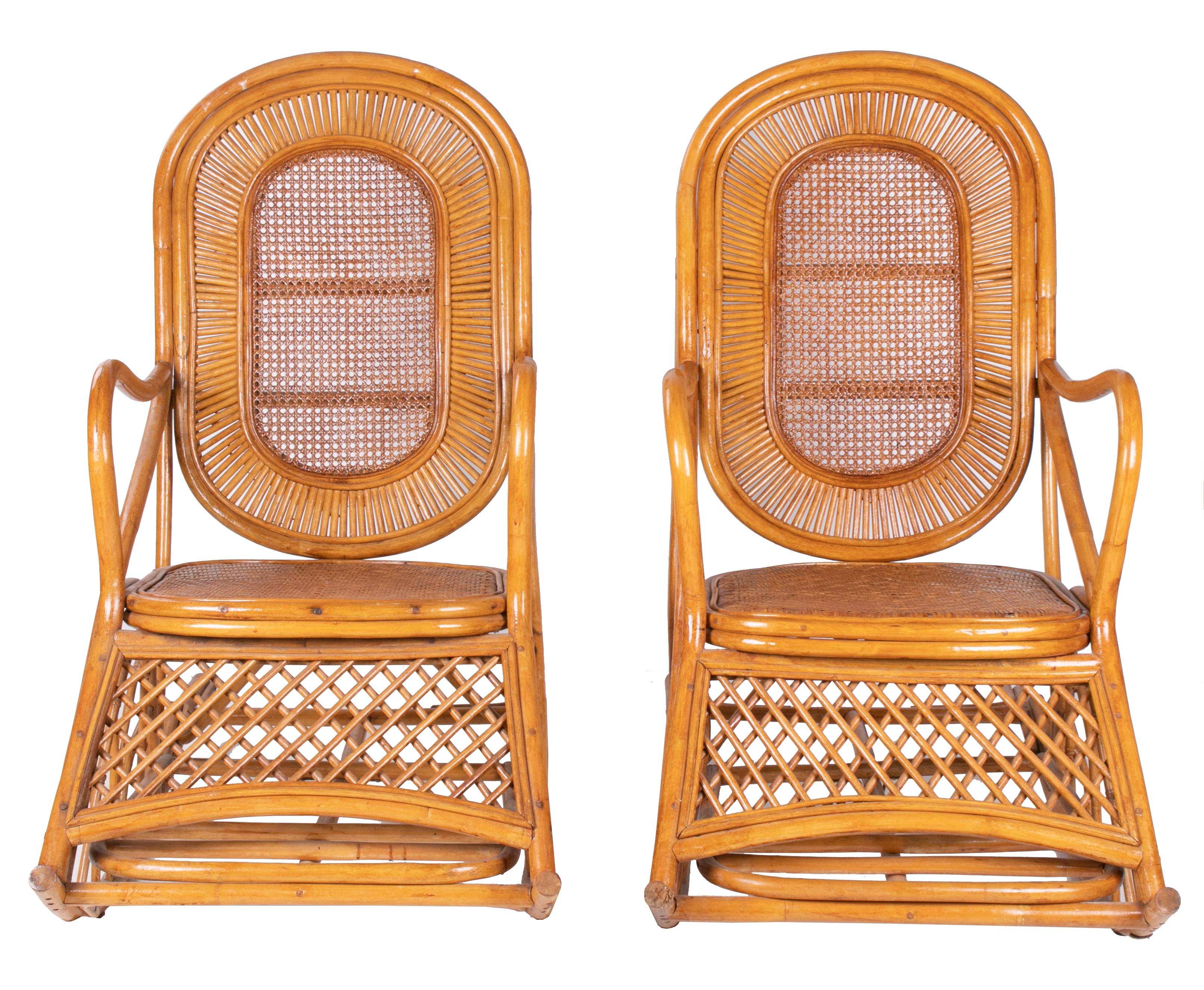 1970s Spanish pair of wood and bamboo rocking chairs with foot rests.