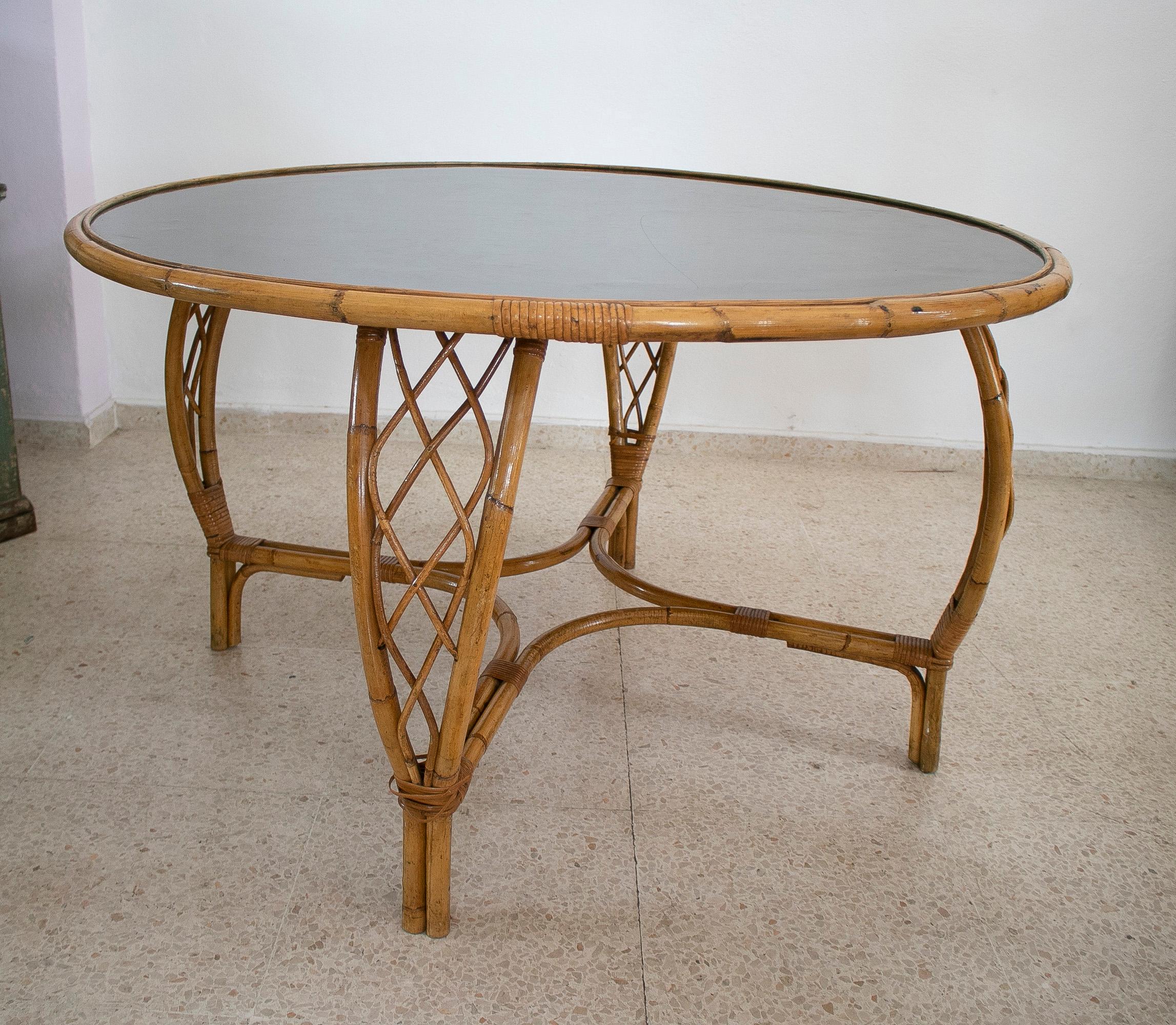 Vintage 1970s Spanish round bamboo table with black Formica top.