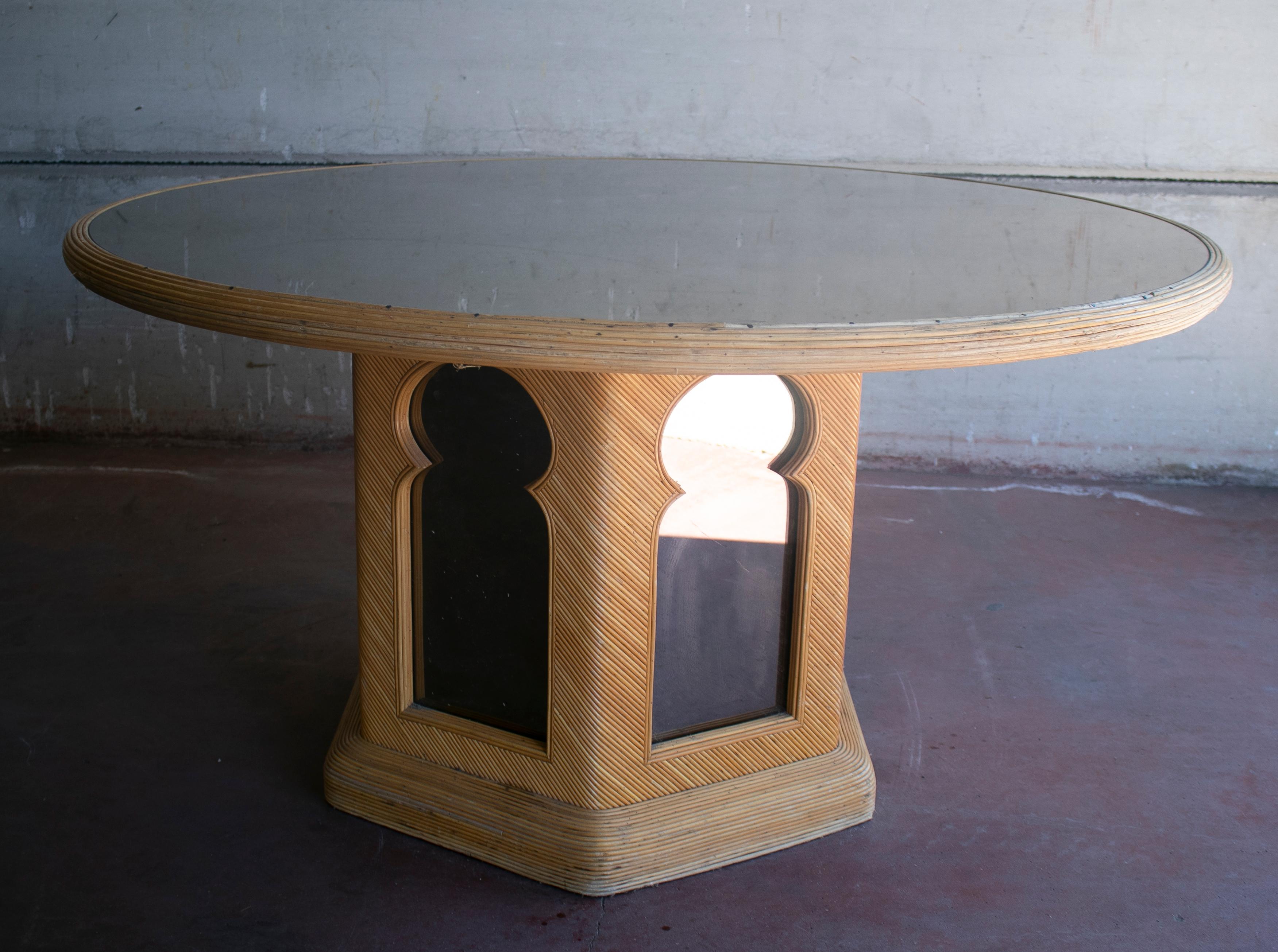 1970s Spanish round bamboo table with mirror top and behind decorative Andalusian arches on the base. 
 