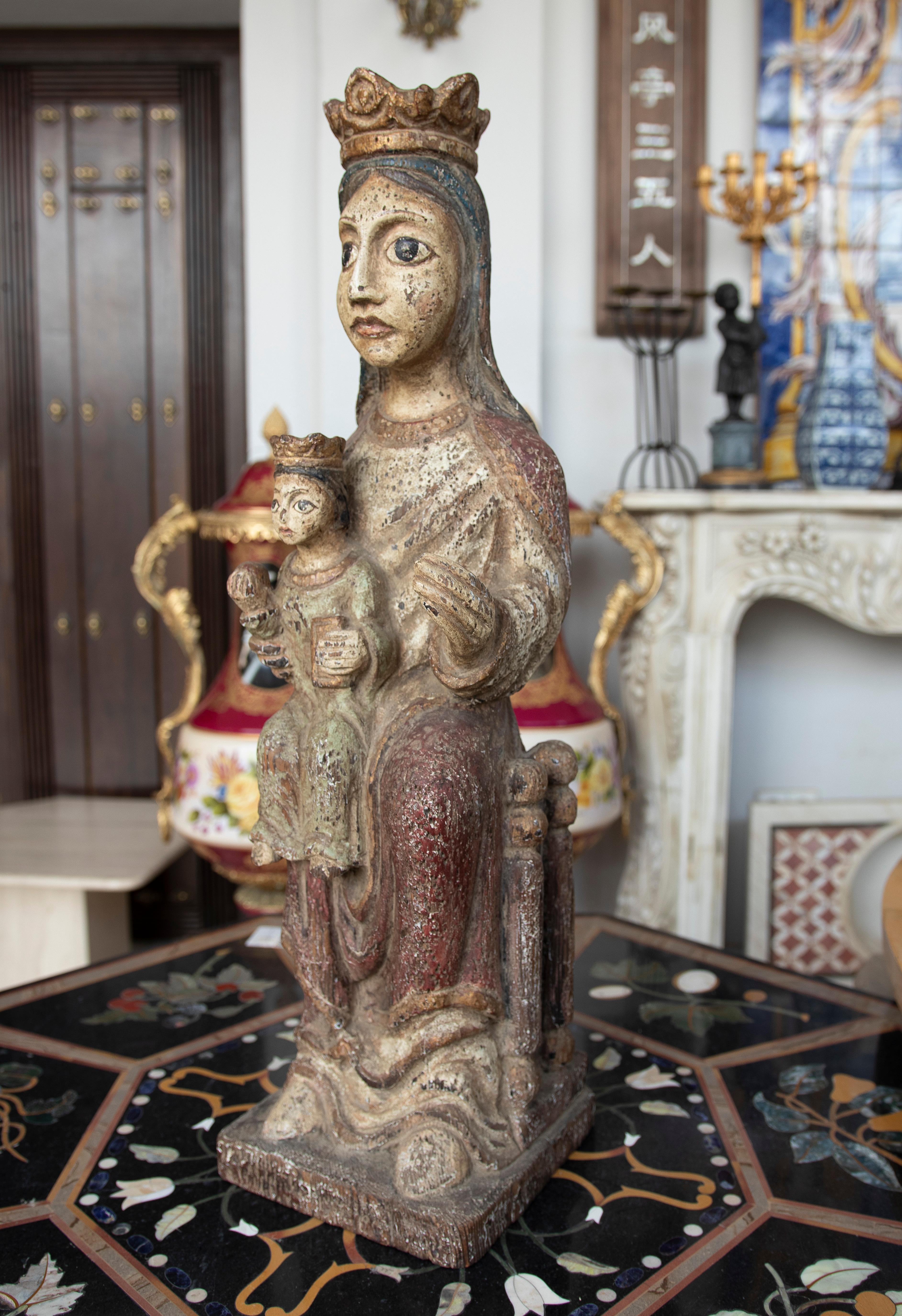 1970s Spanish Virgin and Child hand carved and painted wooden sculpture figure in mediaeval Romanesque style.
