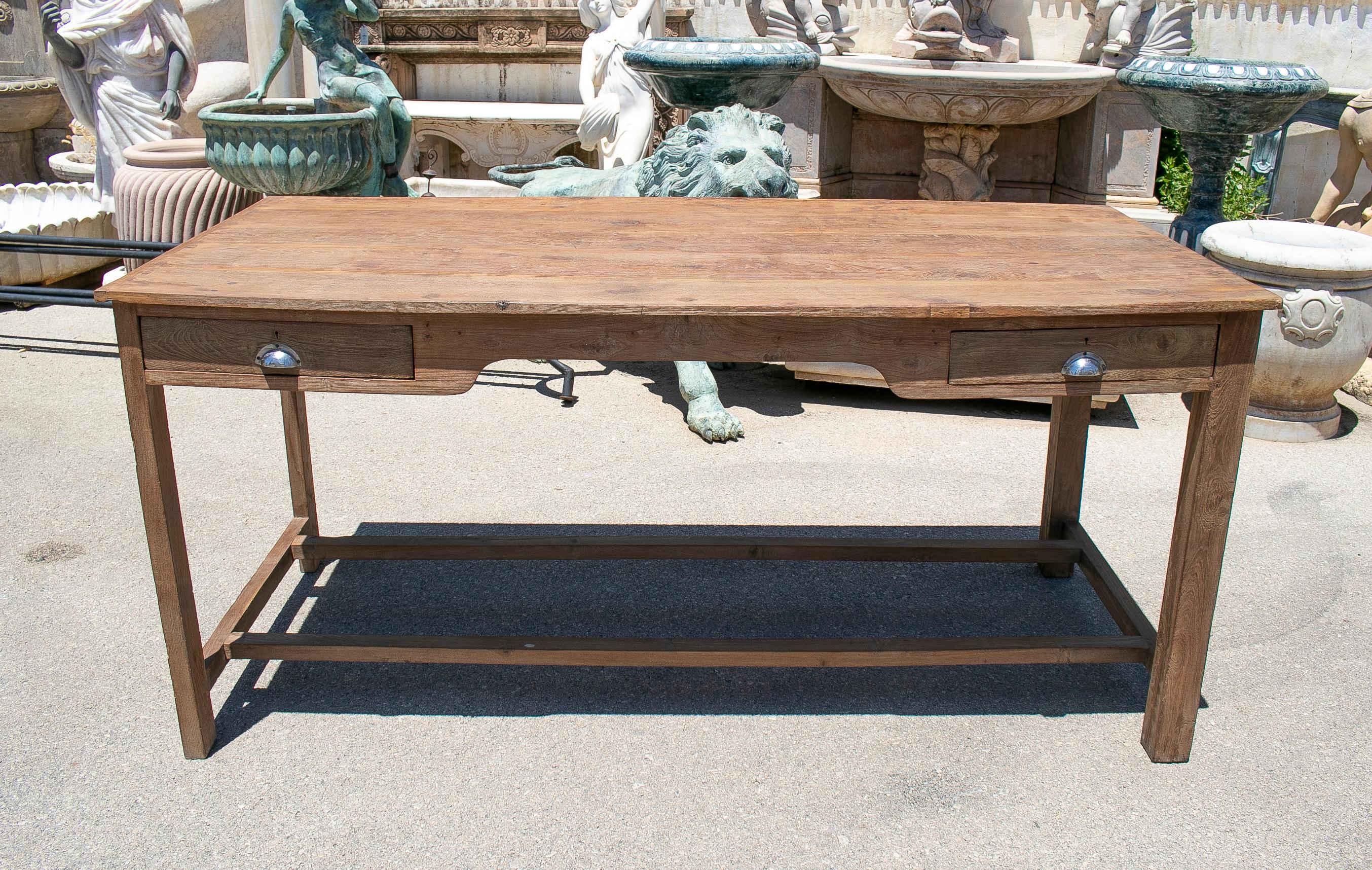 Rustic 1970s Spanish washed wood 2-drawer farmhouse table with crossbeam legs.