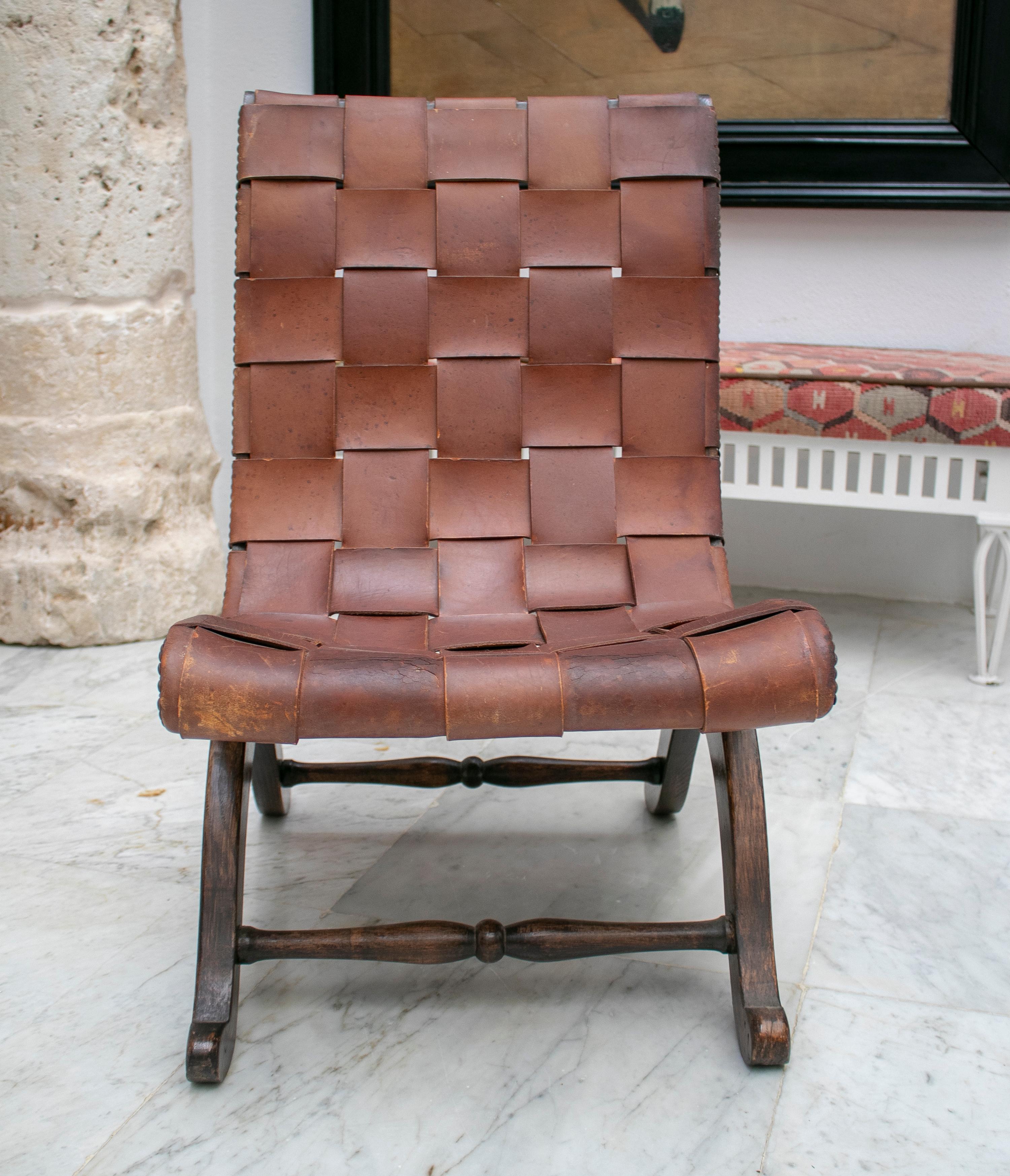 1970s Spanish wood and laced leather chair.