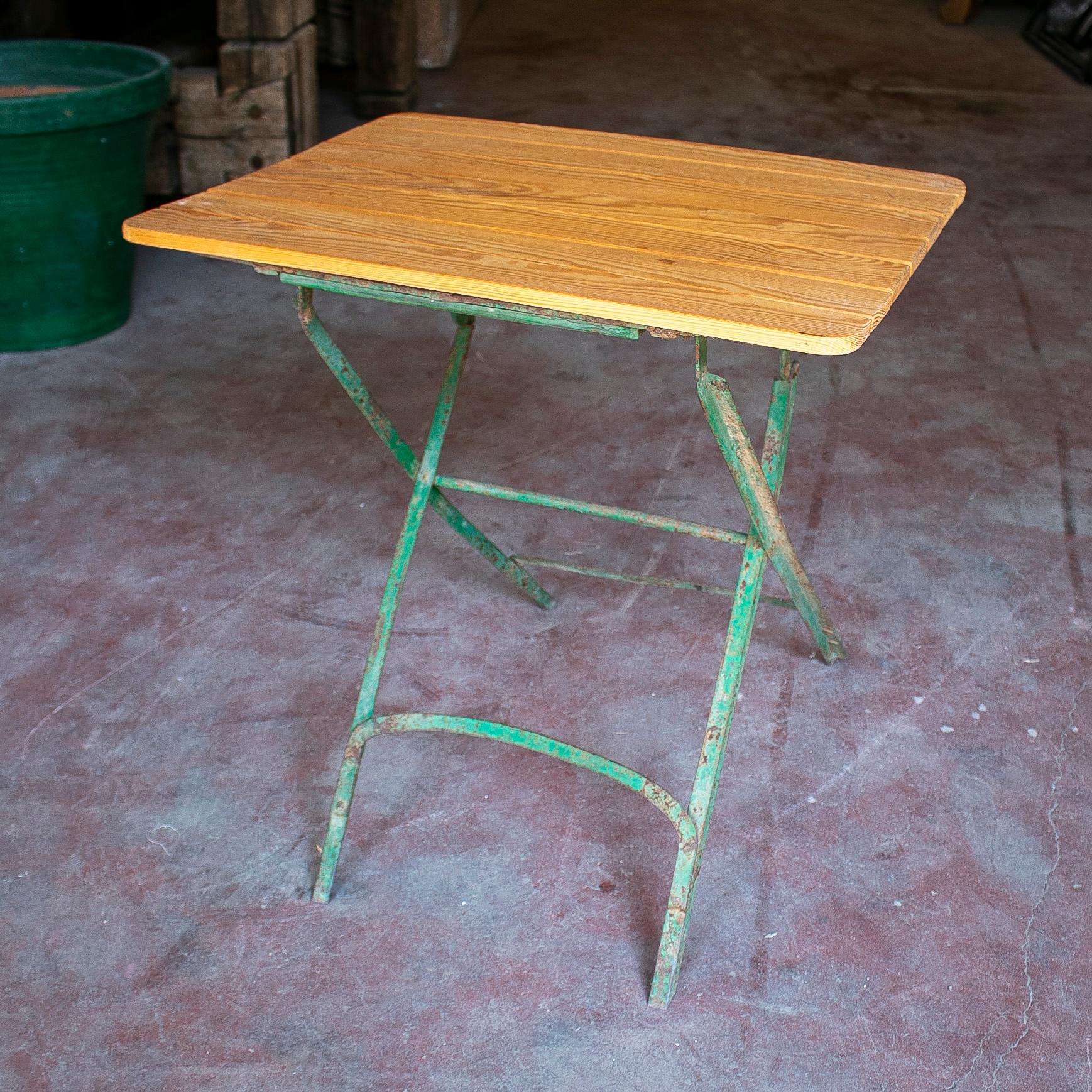 Vintage 1970s Spanish wooden garden table with iron base.