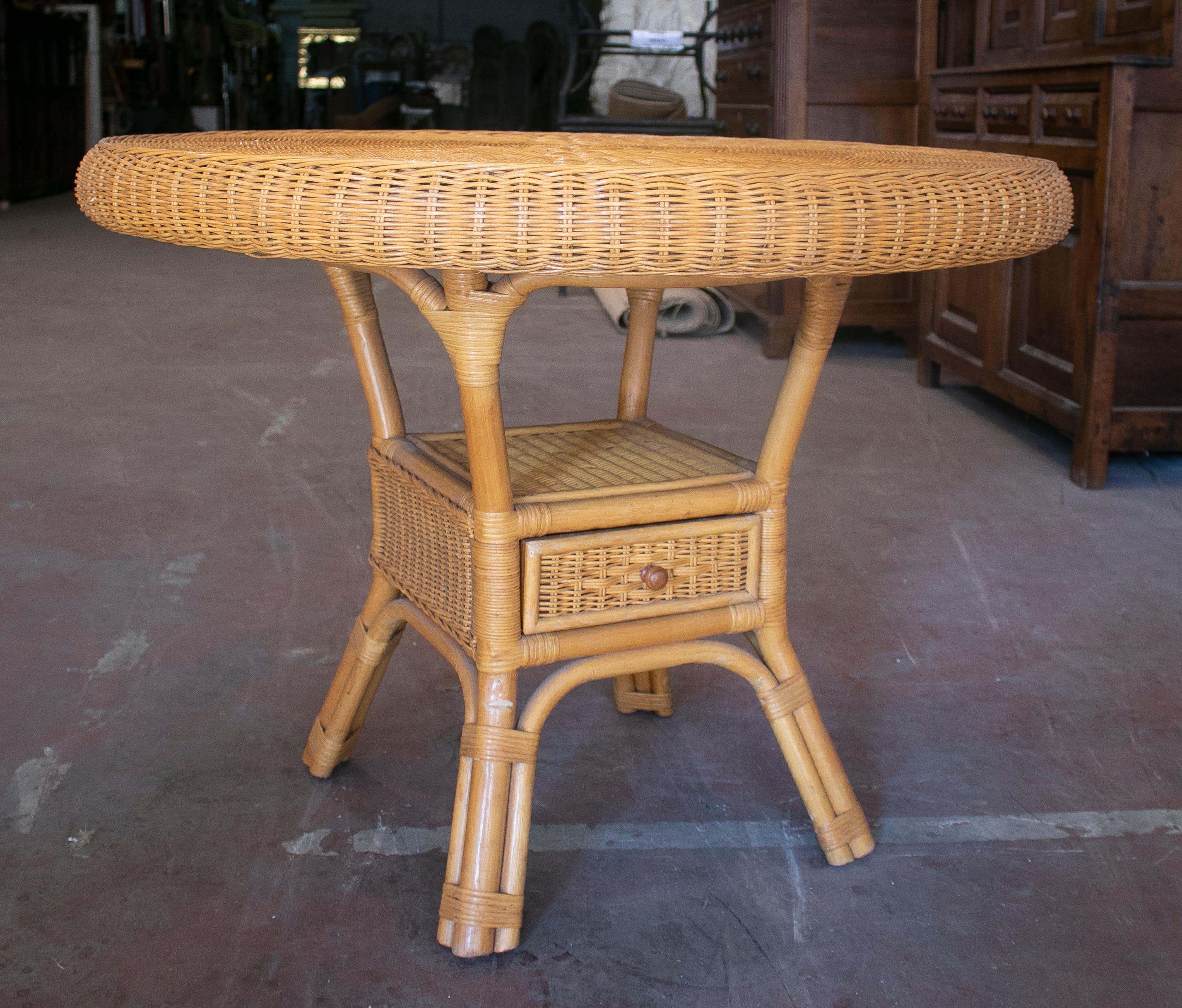Vintage 1970s Spanish hand woven wicker one drawer round table.