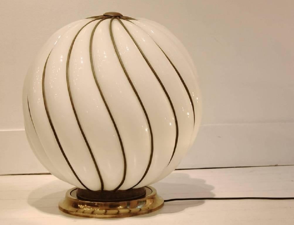 Glamourous 1970s spheric Murano glass table lamp.