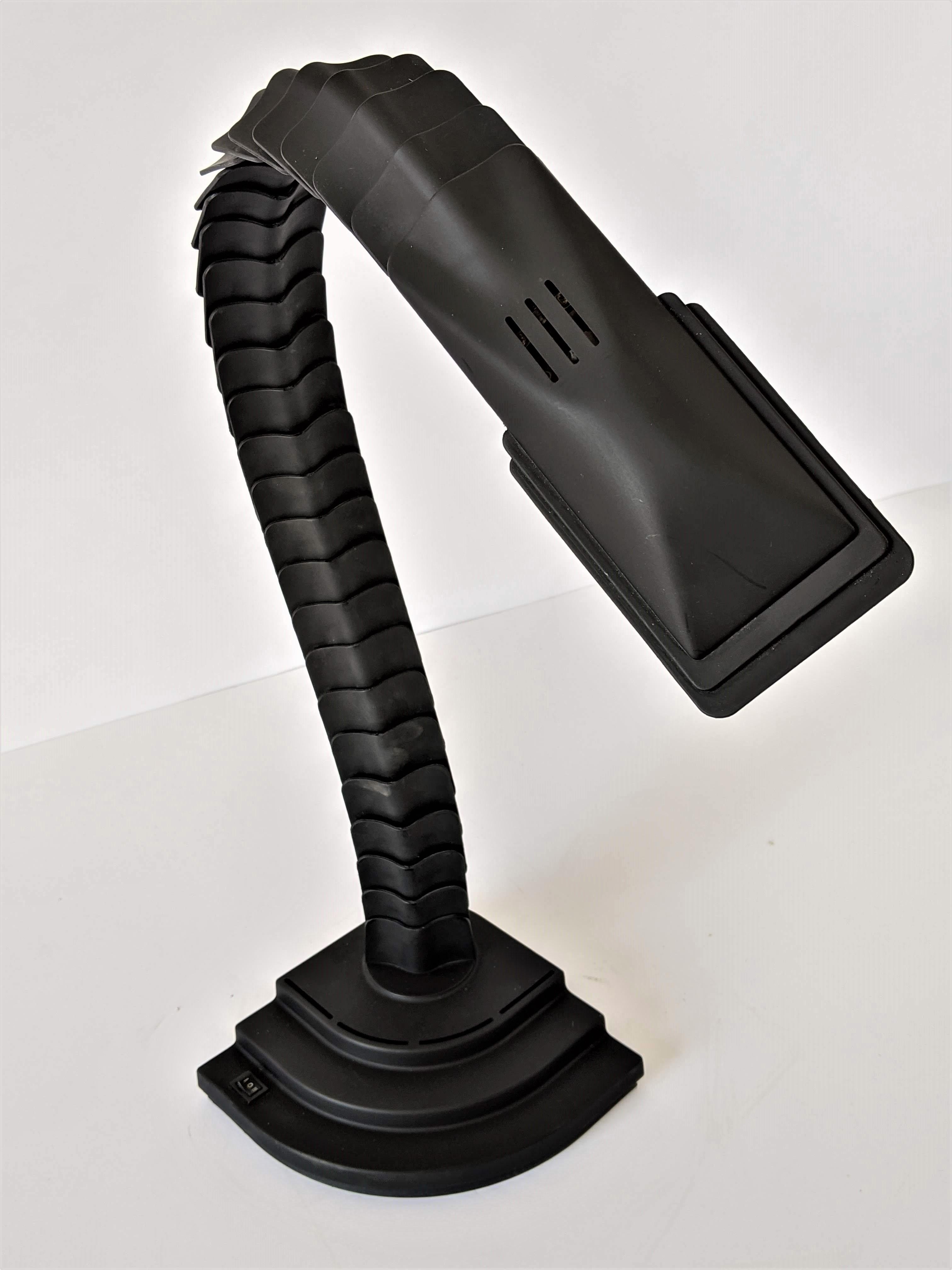 Bold spine shaped and articulated Proteo halogen table lamp.

Playful, easy adjustable in various sculptural shape.

Well made solid construction with black PVC parts and rubber joint.

Measure: 21 in. high when curl as pictured, 36 in