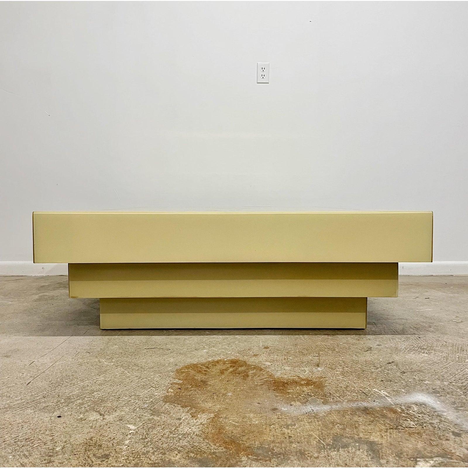 Striking 1970's wood coffee table in cream lacquer with a heavy clear lacquer overlay. Featuring brass squares inlay on the top of the table. This is in excellent vintage condition form a Palm Beach Estate.