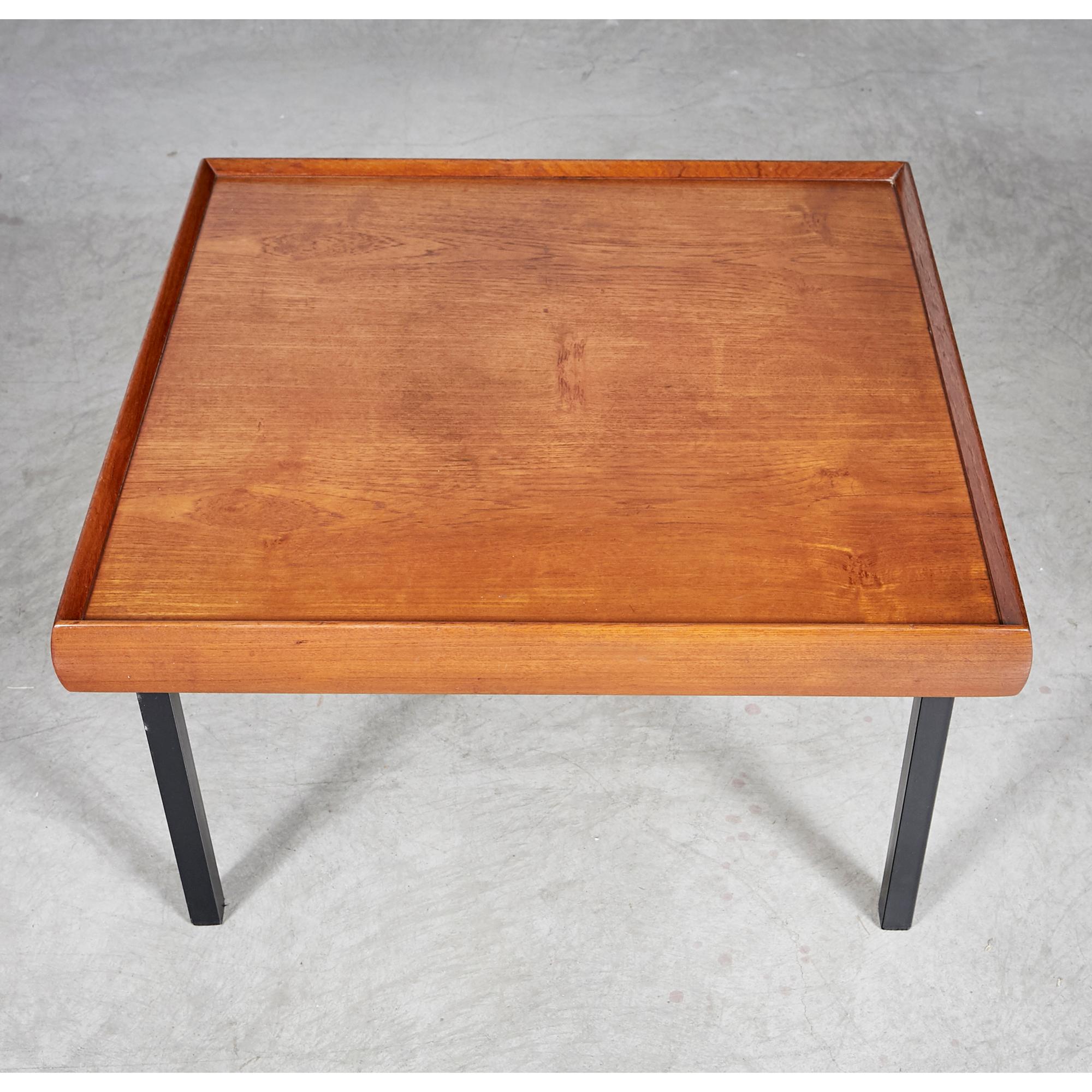 Vintage 1970s square teak wood coffee table with black metal legs. Newly refinished condition. Marked underneath.