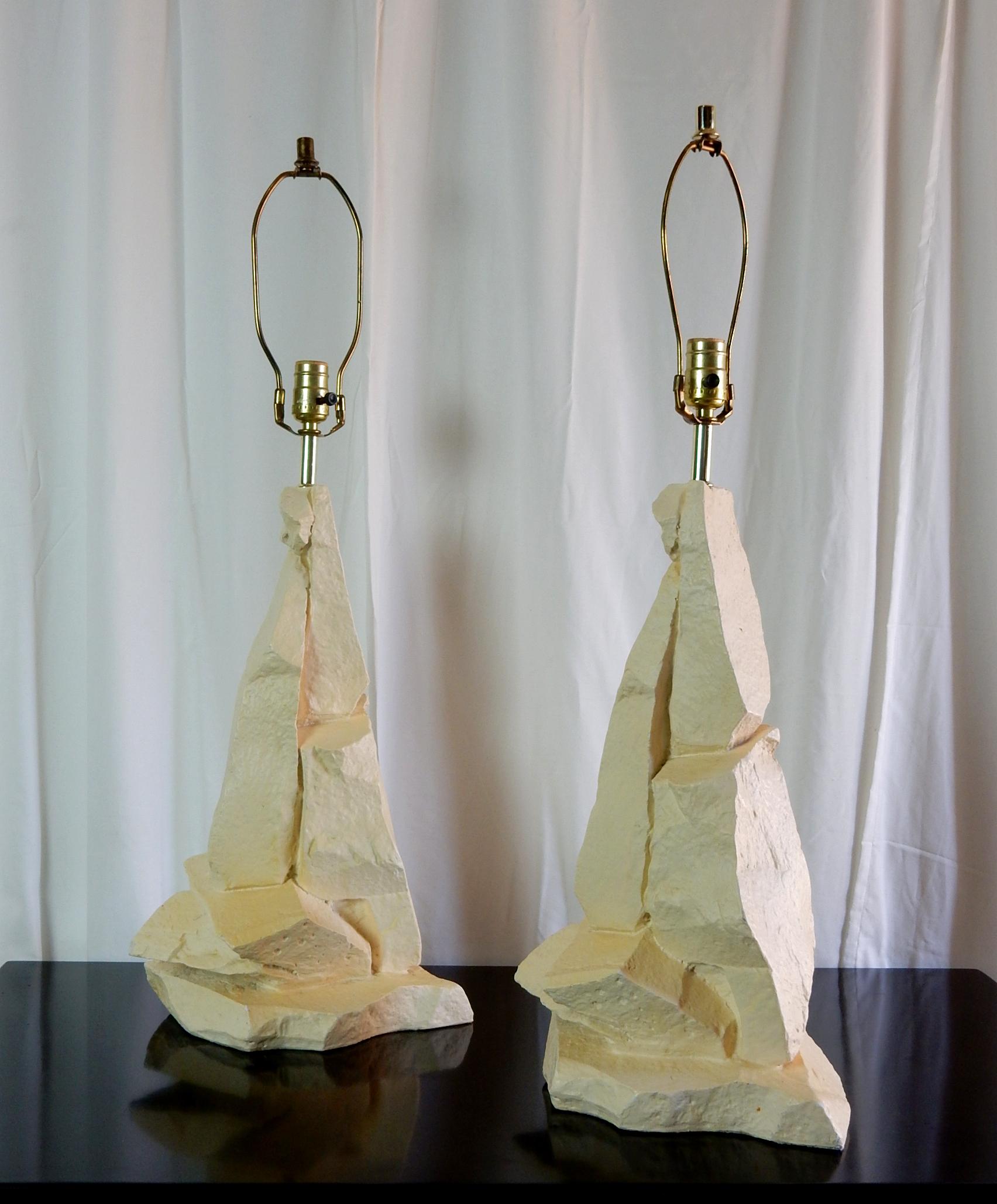 A pair of abstract stacked quarry plaster rocks table lamps by Sirmos.
Striking multifaceted sculptures formed of thick plaster with matte enamel limestone finish.
Completely original finish. No cracks or repairs.
Brass hardware.