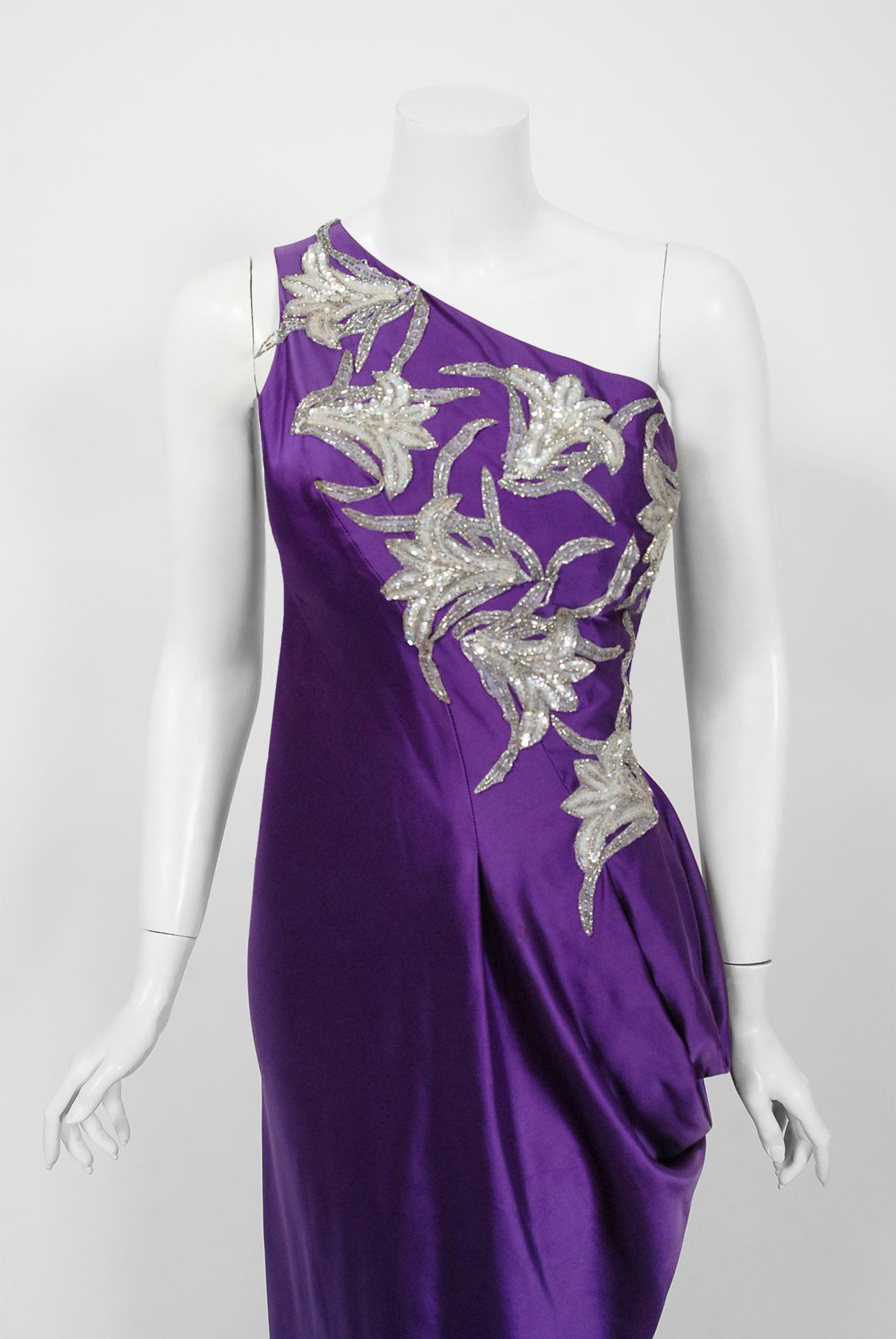 Gorgeous heavily sculpted Stavropoulos Couture purple silk gown dating back to the mid 1970's. George Stavropoulos was a New York fashion designer best known for his innovatively draped dresses and evening gowns that seemed to float in air. Many of