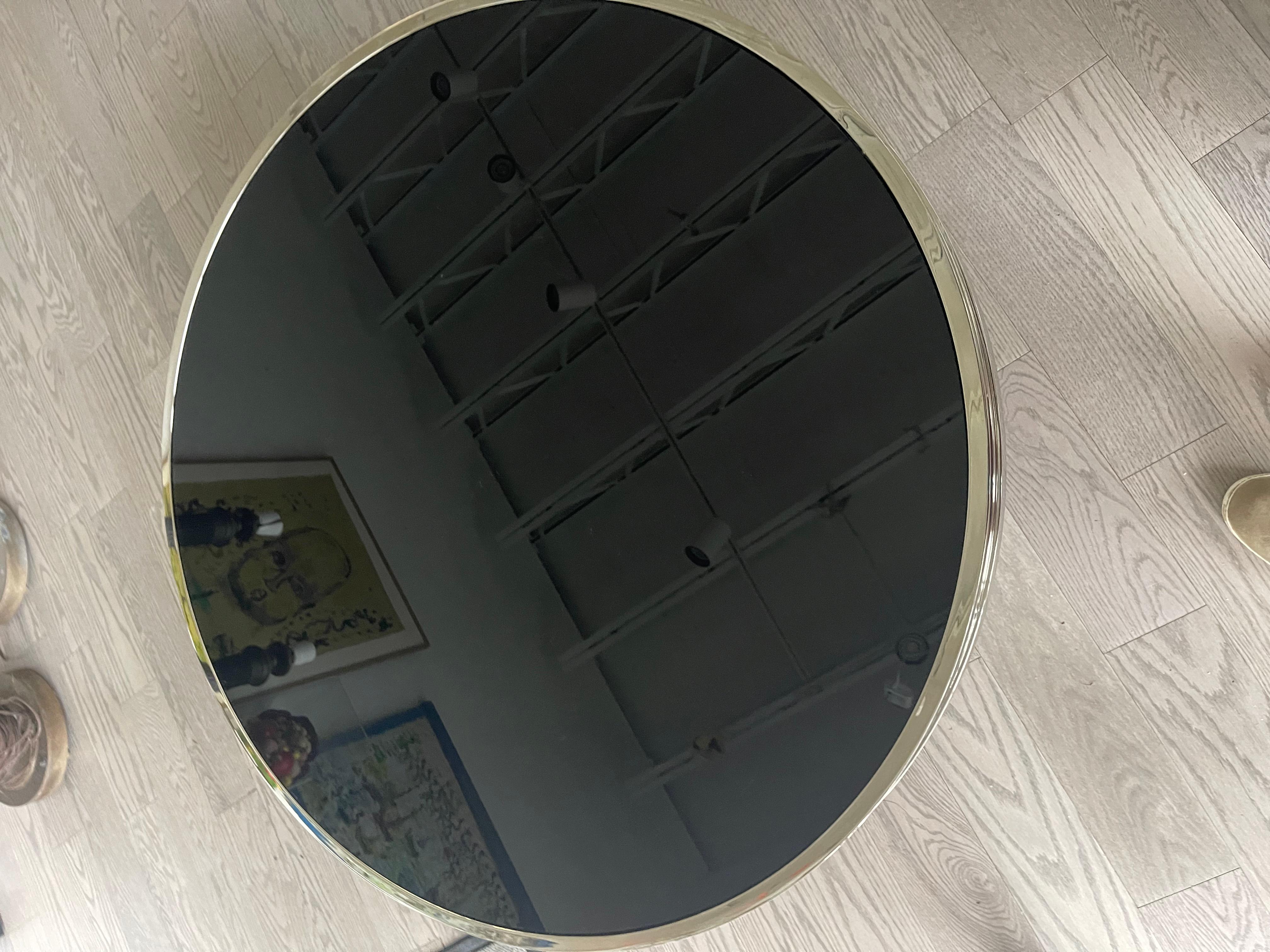 This amazing steel table has two black glass tops. The steel has been professionally polished. The glass has light surface scratches. It’s very well made in the manner and quality of Milo Baughman. It opens up to 56”.