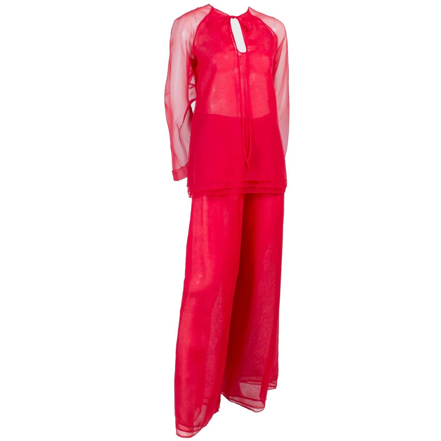 This red chiffon evening ensemble was designed by Stephen Burrows in the 1970's. This evening dress alternative outfit includes a red chiffon tunic with a tiered hemline that ties at the neck, and a pair of high waisted flowing chiffon pants with