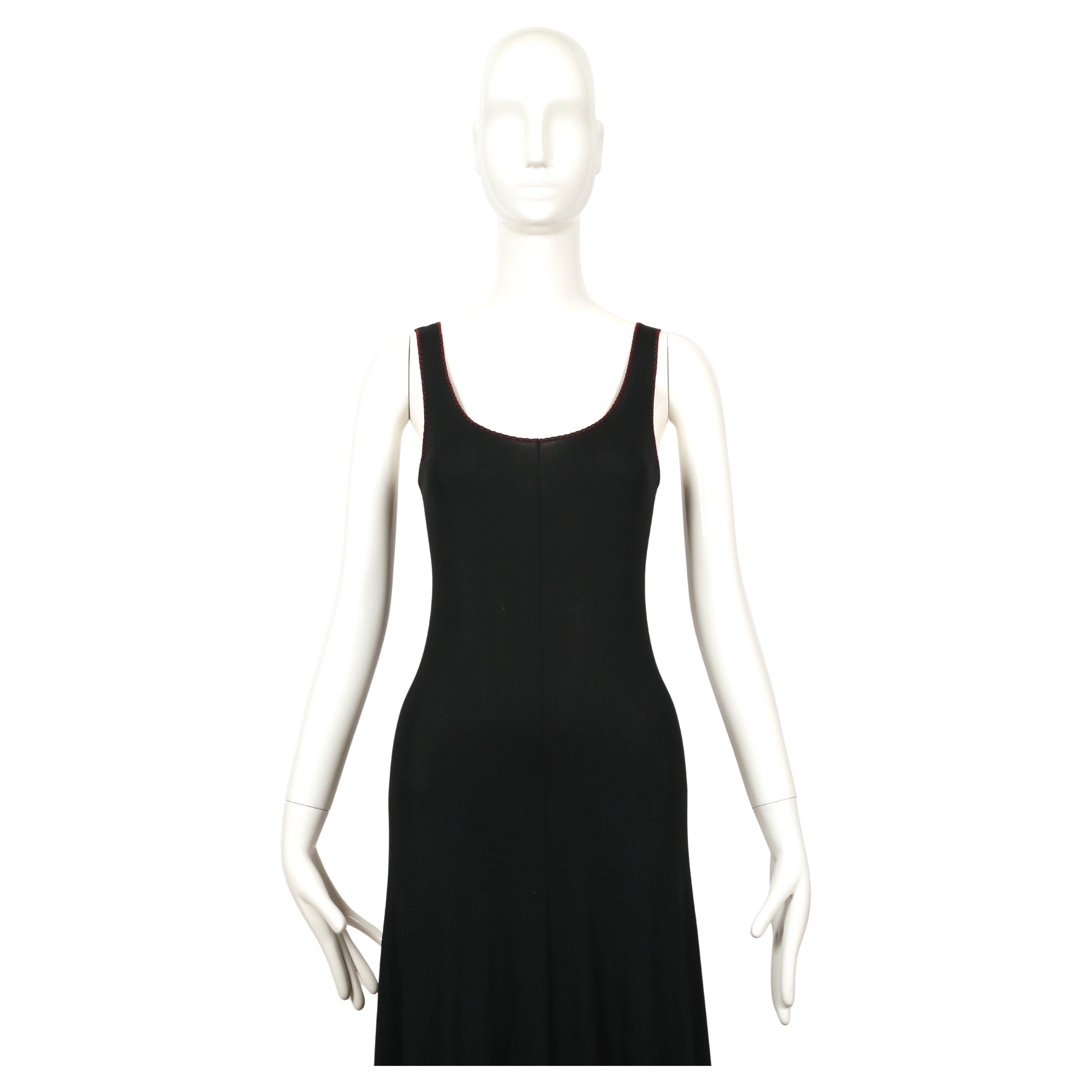 Jet-black jersey dress with red 'lettuce-edge' edges designed by Stephen Burrows dating to the 1970's. Flattering center seams down the front and back as well as the side.  Dress is labeled a 10 however this fits very small and would best suit a US