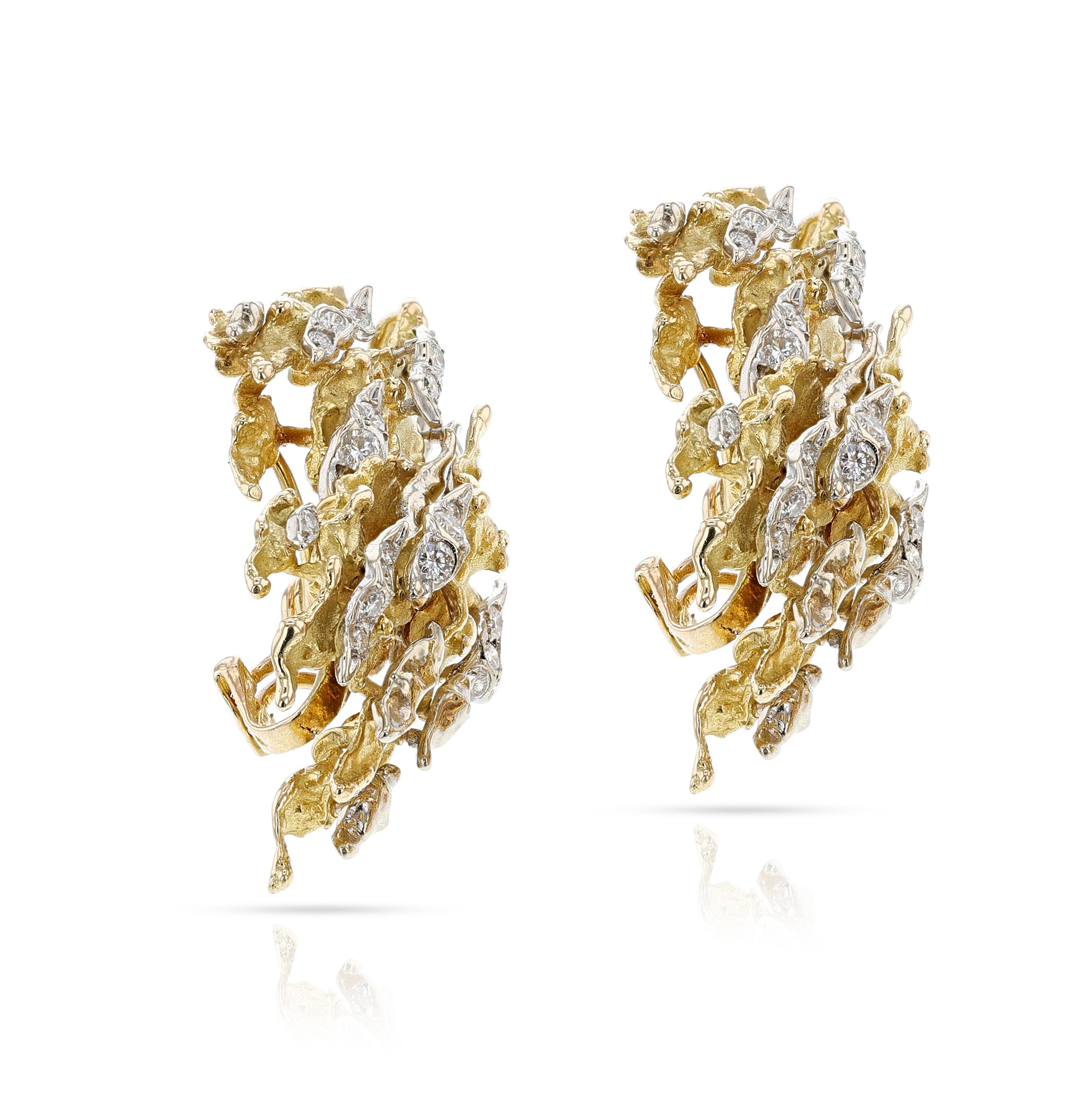 A pair of 1970s Sterlé Yellow and White Gold Earrings with Diamonds. The design has wavy patterns with brilliant cut diamonds set in white gold. Signed and numbered. The length is 2.04 inches and the width is 1.06 inches. The total weight is 40.55