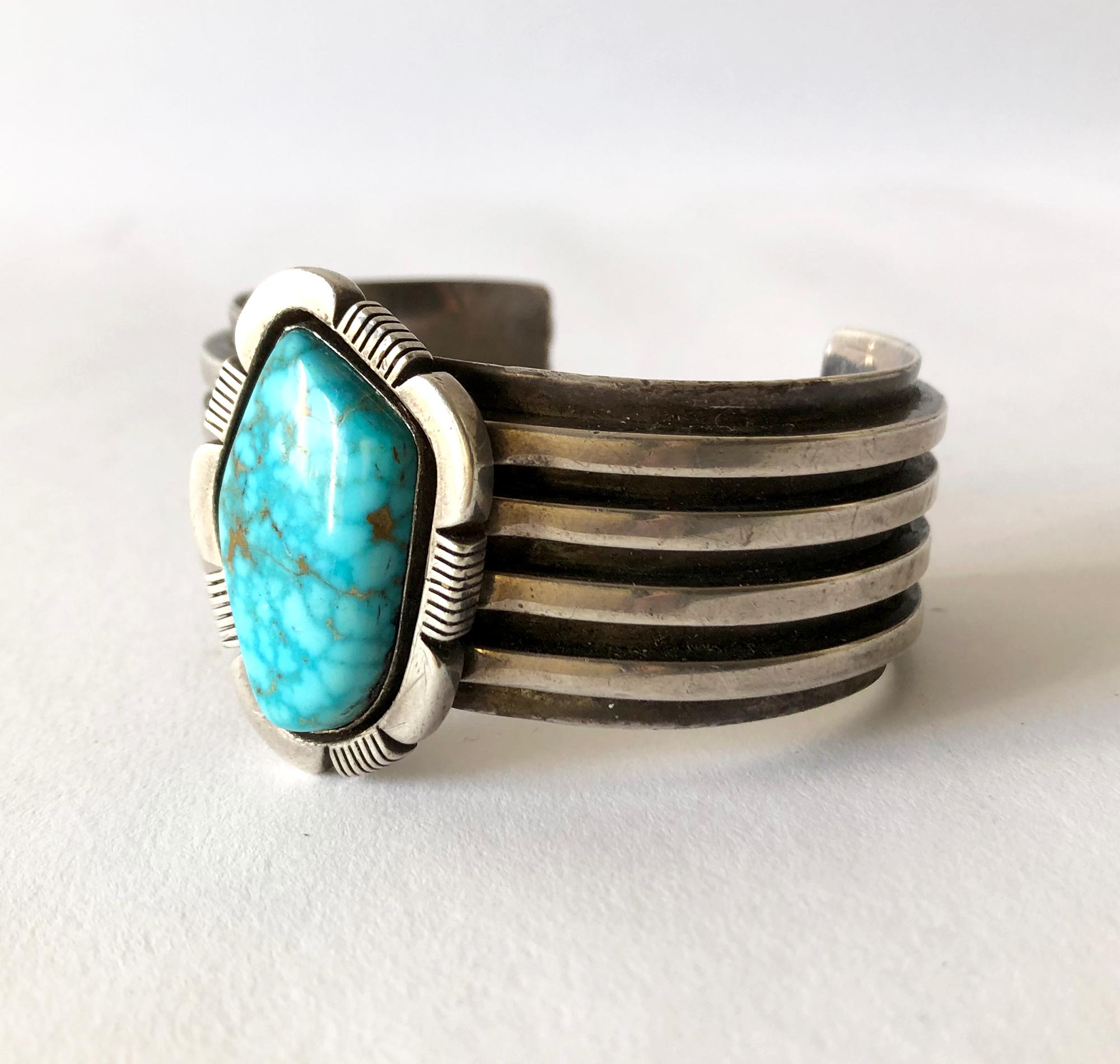 Heavy sterling silver and turquoise Navajo bracelet, circa 1970's.  Turquoise has natural fissures in the stone and should not be mistaken for cracks. The stone is smooth to the touch.  Bracelet has an inside circumference of 6.5