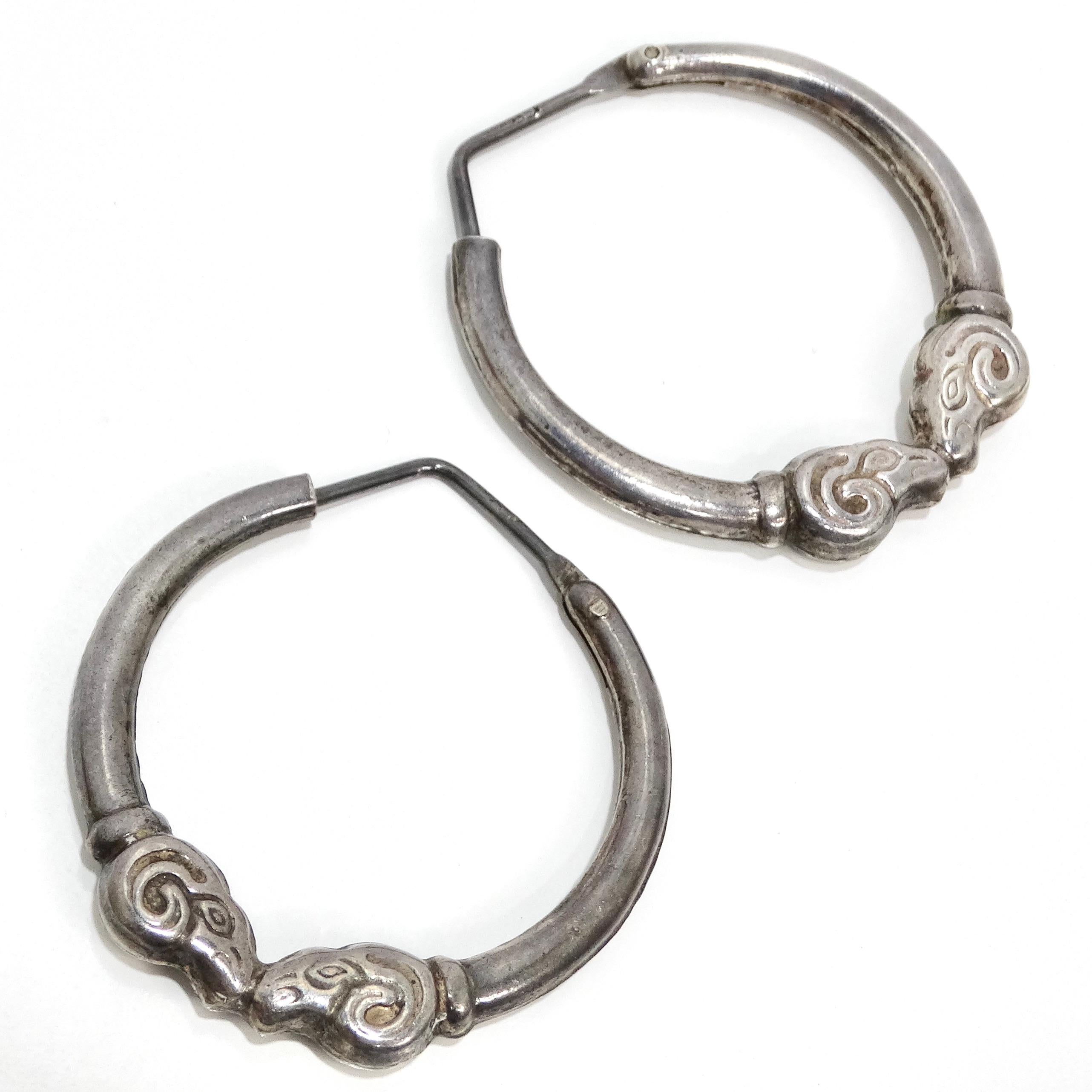 Introducing the exquisite 1970s Sterling Silver Double Ram Hoop Earrings, a vintage treasure that exudes timeless elegance and unique craftsmanship. Crafted from sterling silver, these hoop earrings feature a stunning double ram head etched into the