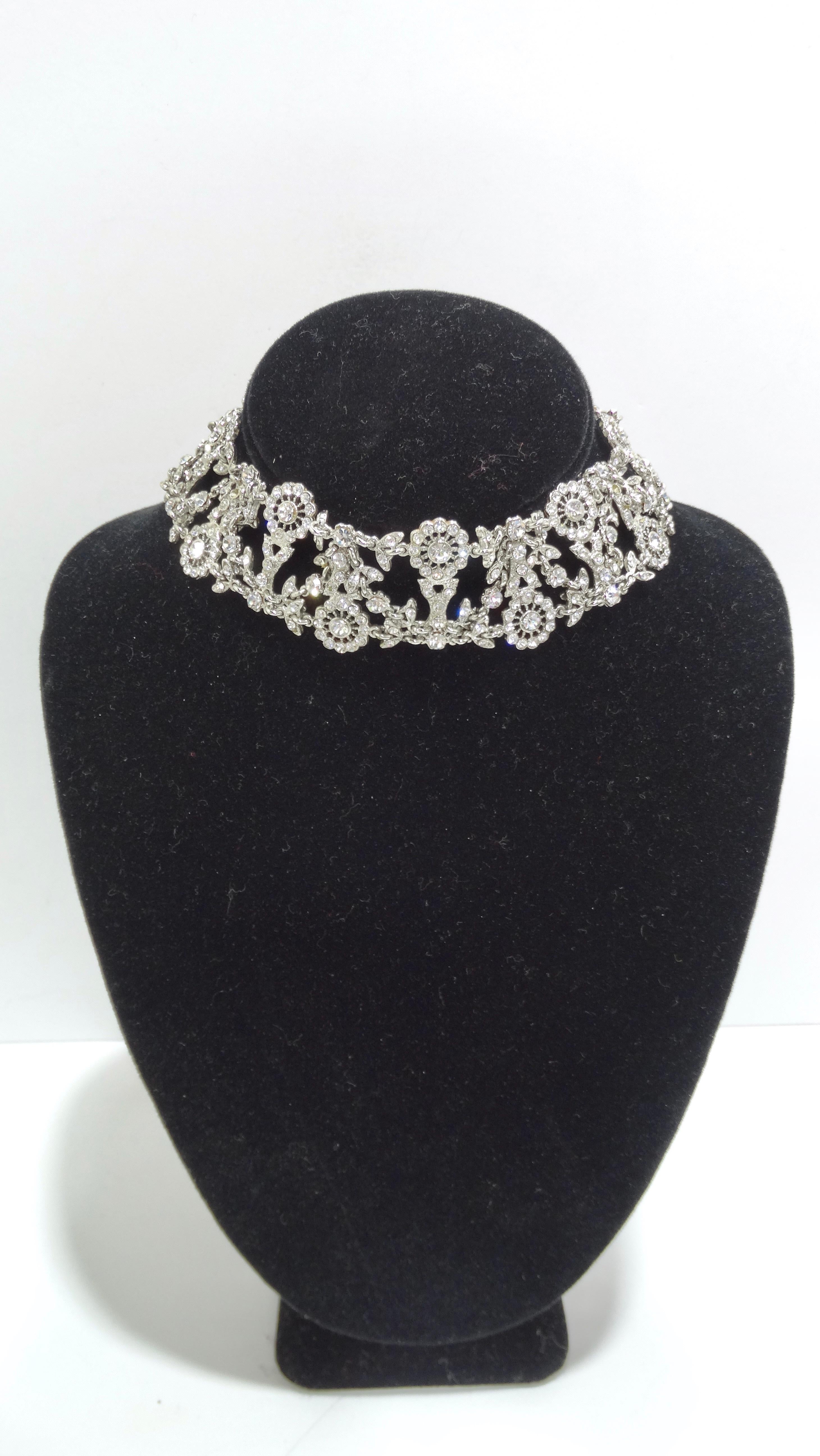 Feel your most glamorous and feminine self in this 1970's sterling silver choker. The whole necklace is beautifully bejewelled in addition to flower detailing. The length is slightly adjustable. A couple jewels have fallen out. When thinking about