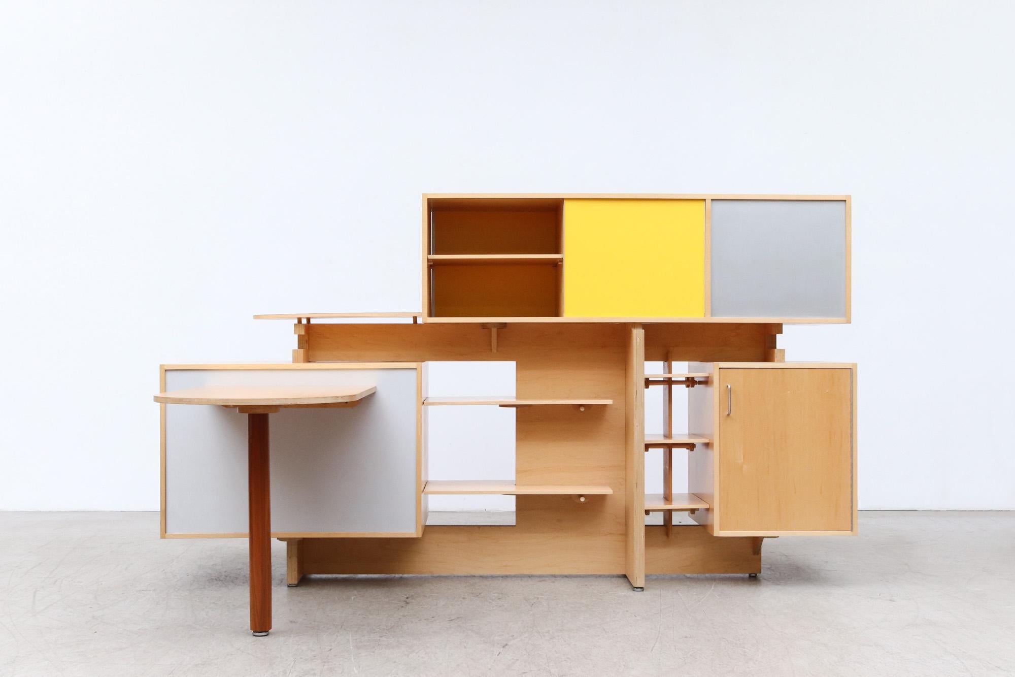 Beautiful 1970's Stewart MacDougall Room Divider with Desk, Multiple Shelves, Storage Cabinets, Drawers, and Waste Bin. Made from birch, walnut, formica and brushed metal. Upper sliding cabinet doors. Unique little yellow ball accent for decoration.