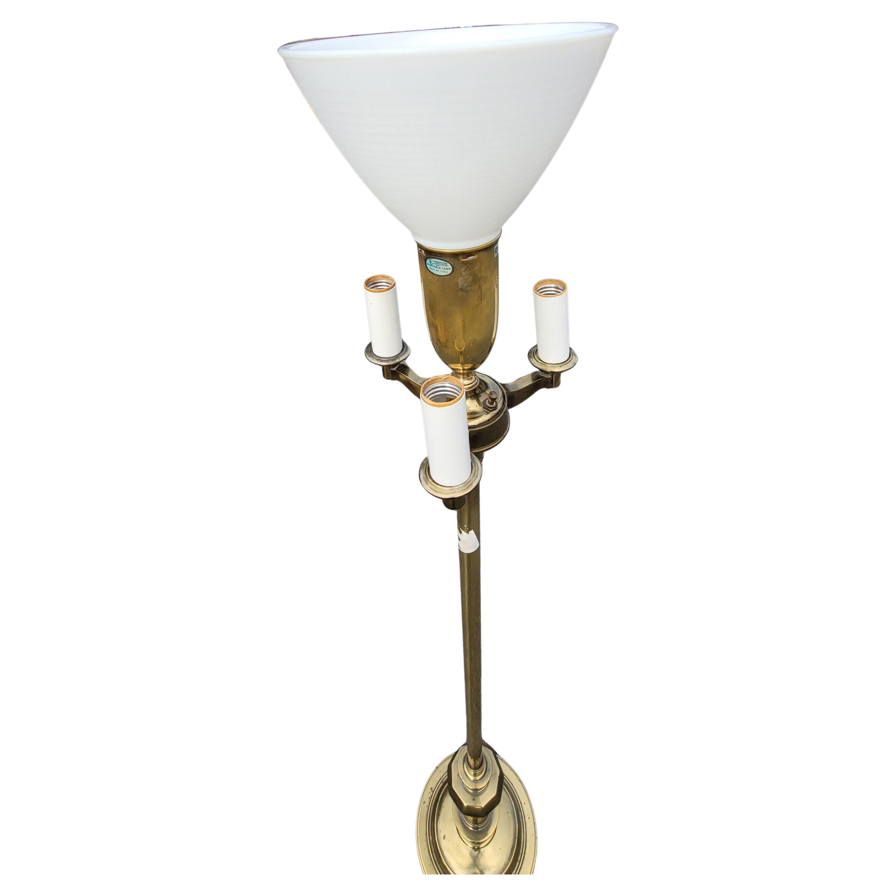 A 1970s Stiffel Torchiere brass floor lamp with milk glass shade. Features 3 peripheral lights and Center light. Great quality. Measures 10