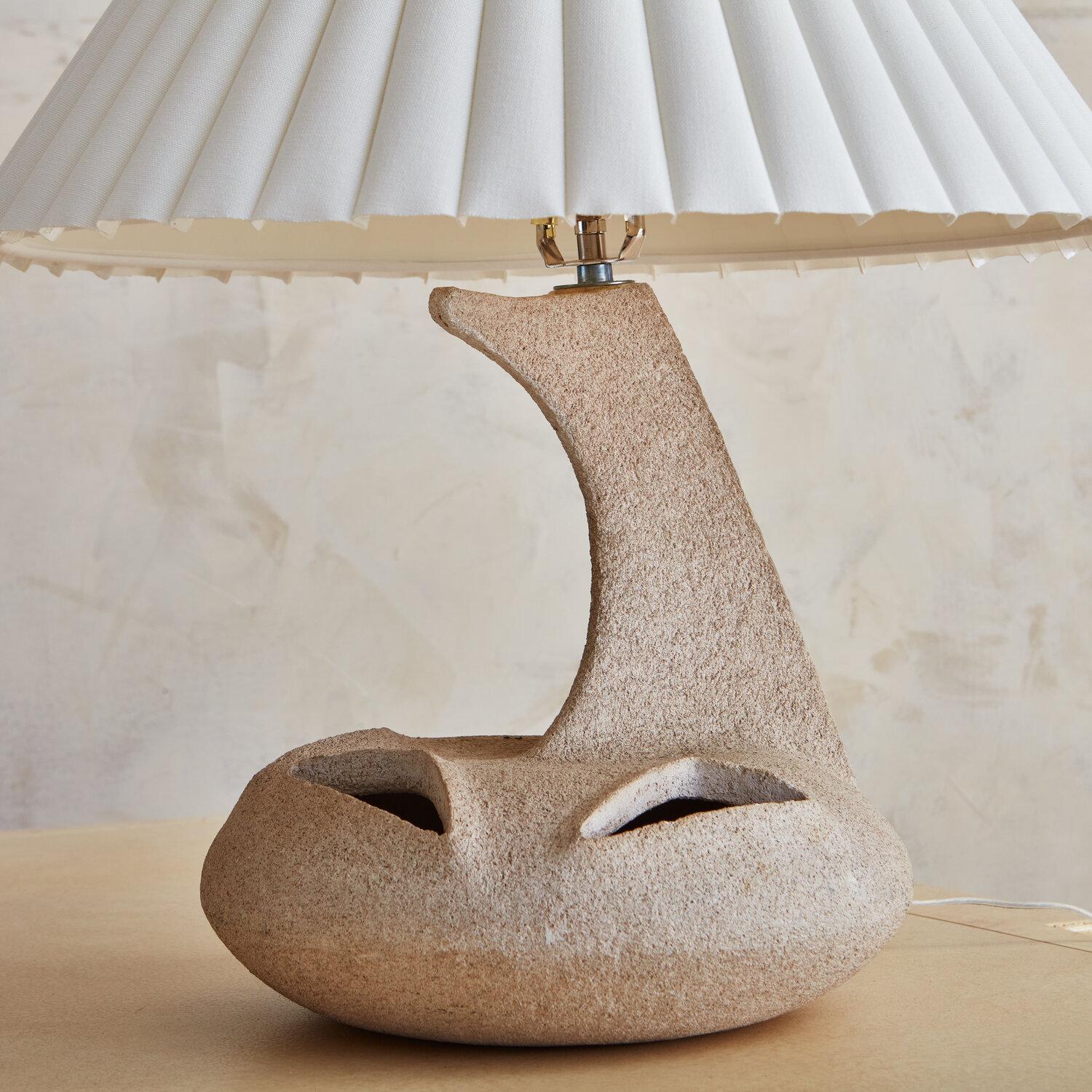 A stone and resin composite lamp from the 1970s. This piece presents great texture and shape as a piece of accent lighting. 

 