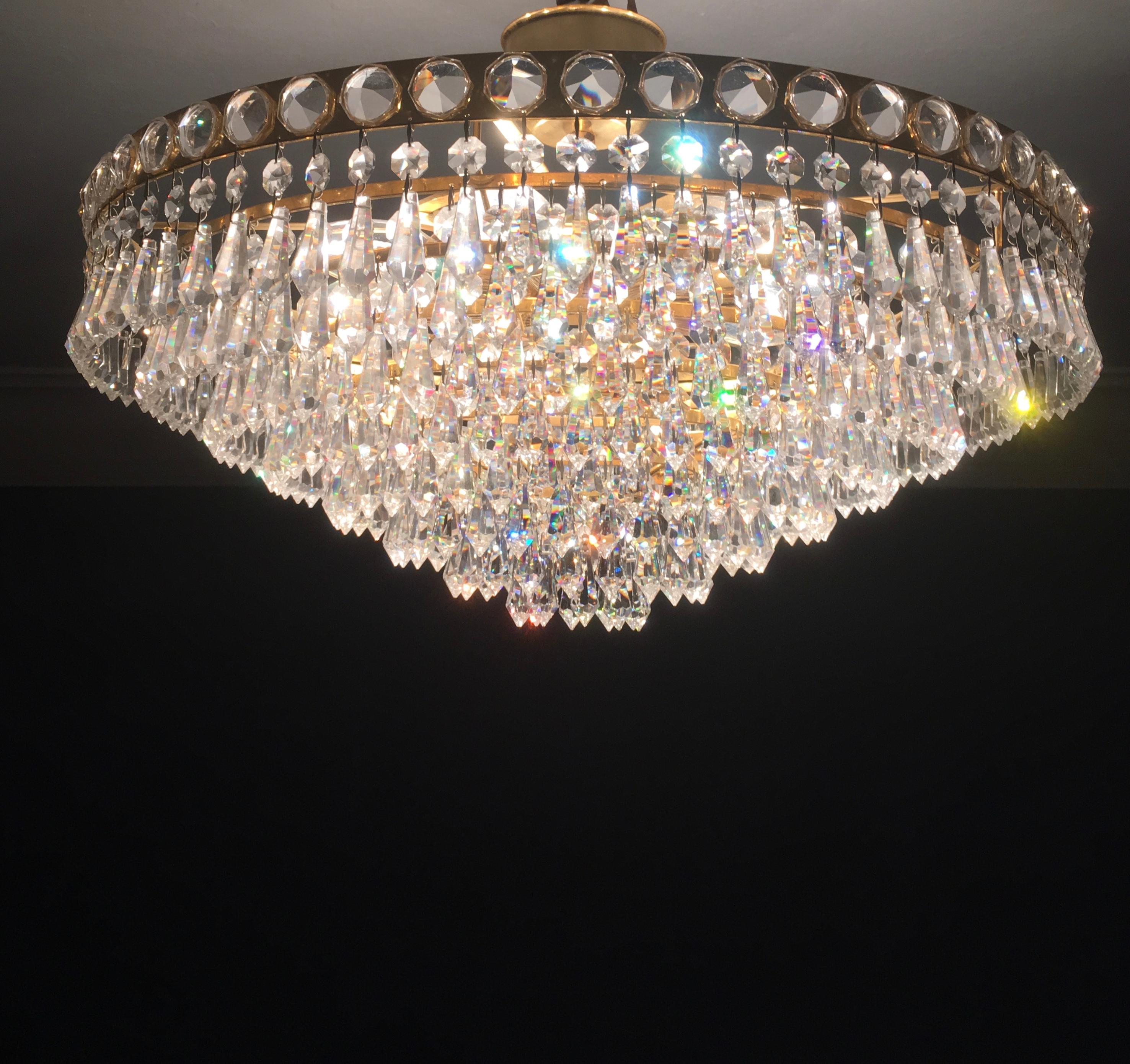 A 1970s strass/Swarovski, lead crystal - Chandelier by Joska, Bavarian Forrest, Germany.
The real and original Strass/Swarowski crystals have a minimum percentage of 24% lead, this leads to the
high quality, the brilliance and light color of this
