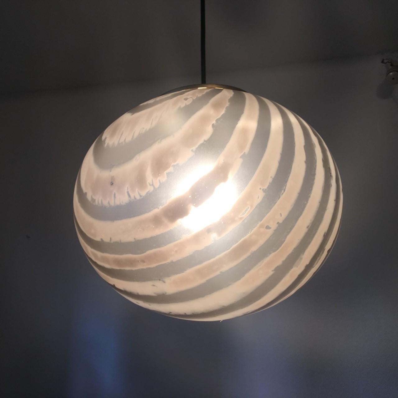 A glass ball lamp with 1970s fashionable stripes from the German Manufacturer Peill & Putzler. In the USA these models were distributed under the name of Koch & Lowy. The fixture requires E 26 / 27 Edison bulb up to 60 Watts. Equipped with original