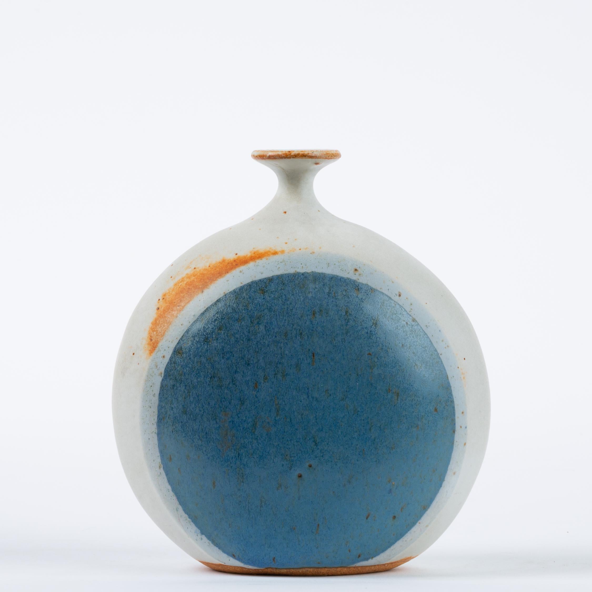 A popular design and characteristic glaze pattern from Hickory Grove Studio, a Pennsylvania-based ceramics venture by partners Isabel Parks and Warren Hullow. The small vessel has a flared lip and dainty neck on a wide-hipped body. Each side of the