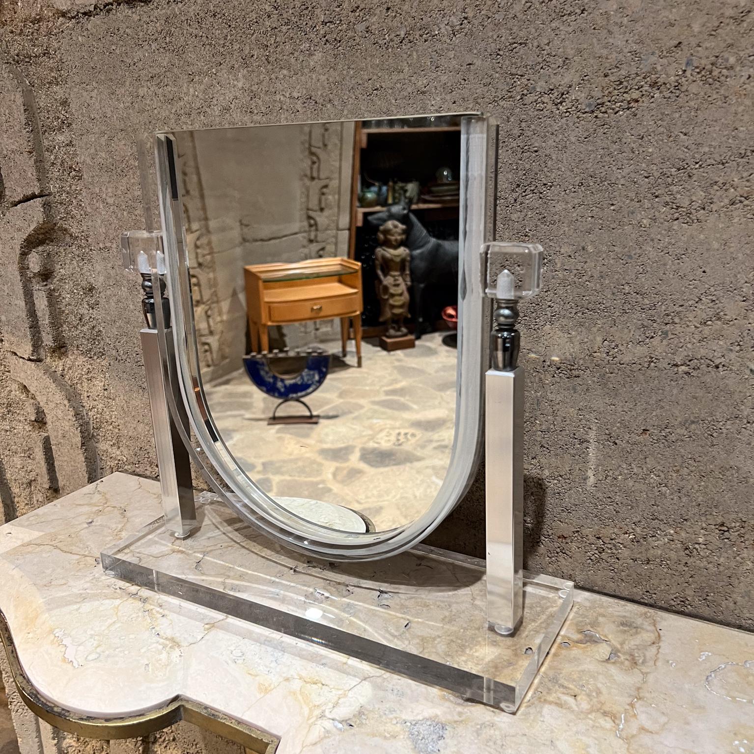 
1970s Modernist Lucite Chrome Vanity Table Mirror
in the style of Charles Hollis Jones
14tall x 14 w x 5 d
Preowned original vintage condition.
See images provided please.