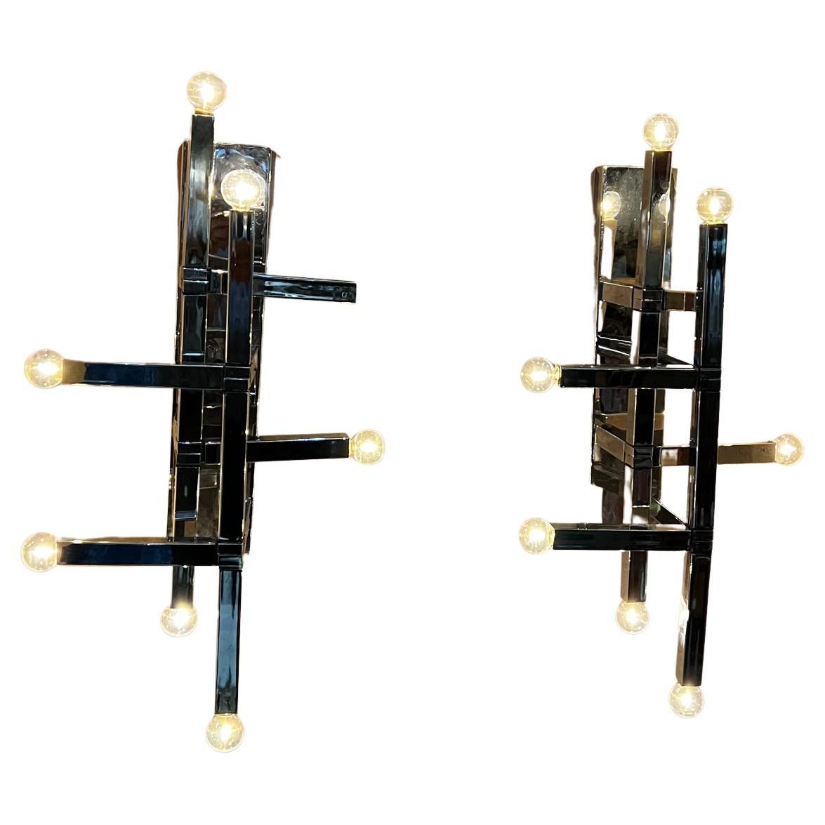 1970s Spectacular Stilnovo style wall sconces from Mexico.
Vintage set made in Mexico after Gaetano Sciolari Futuristic Series.
Stunning geometric overlap.
Each sconce takes 8 candelabra bulbs.
Preowned condition restored; new chrome plating,