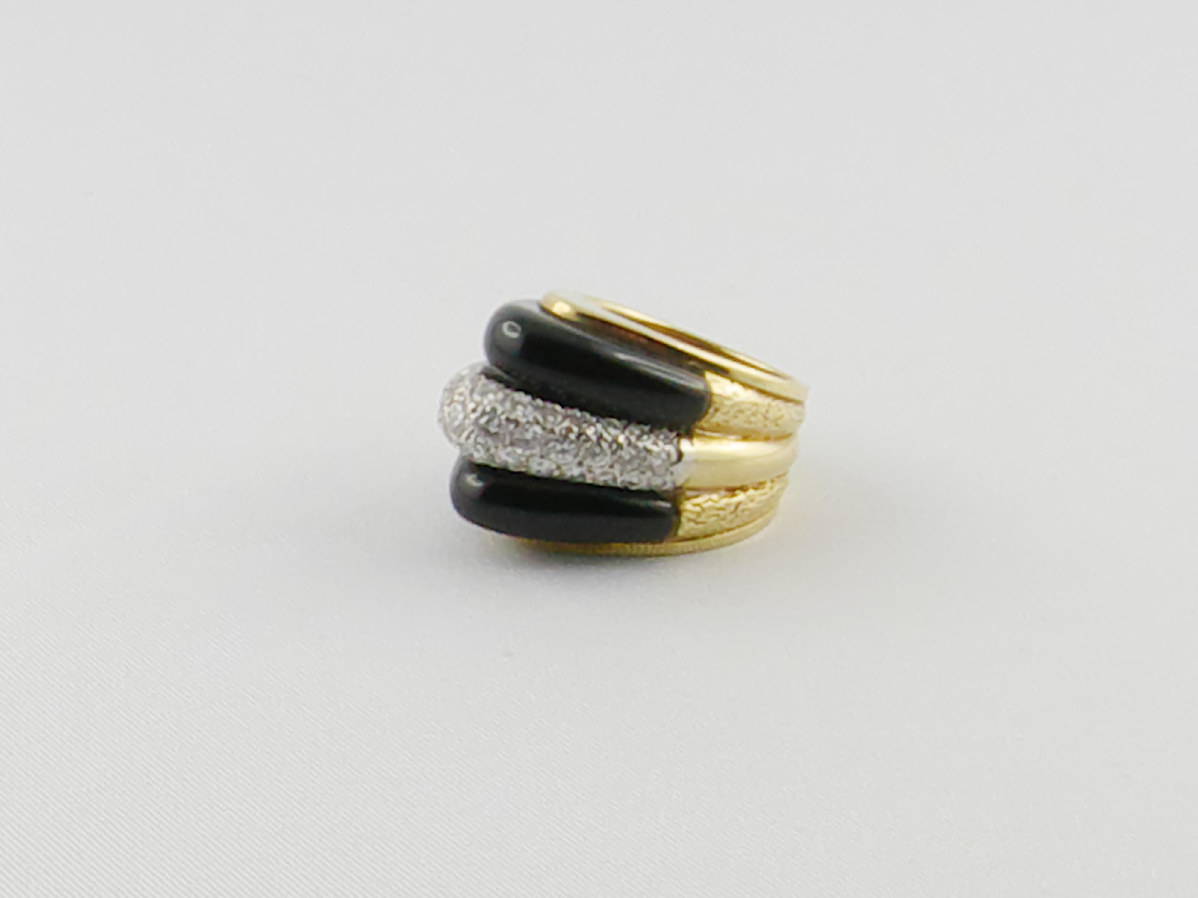 A Fashionable and Unique 1970s Ring showcasing two bombé Onyx elements and round Brilliant Diamonds set in 18 karat Yellow Gold 
Diamonds weigh approximately 1.20 carats 
A stunning chic piece you can wear from day to night 
Size 5 1/2 Could be