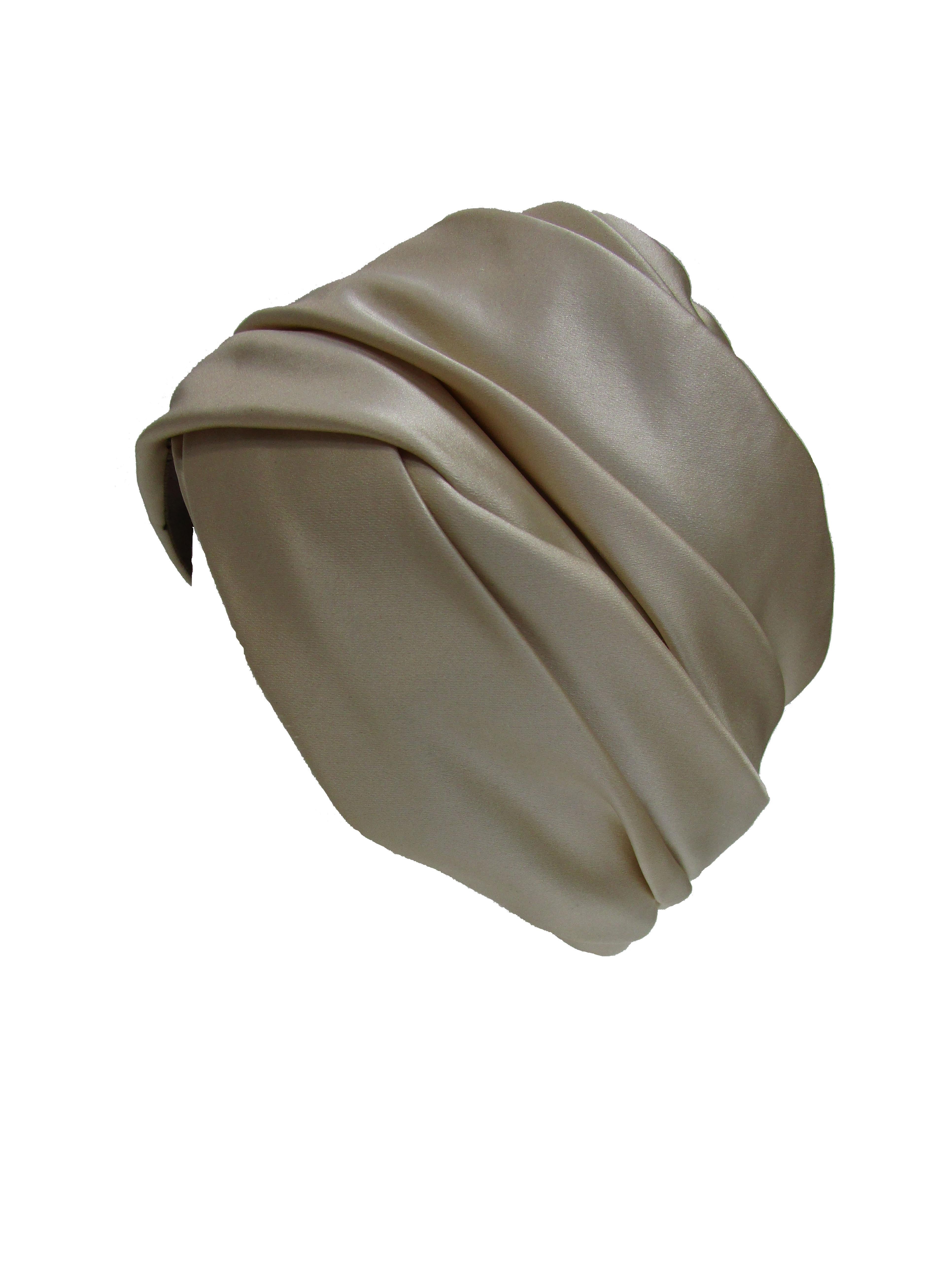 We adore this impeccably crafted silk turban by Irene of New York. It has a mesh lining and luxurious silk that wraps and pleats around the head. Turbans and scarves were a popular accessory in the 70s.



