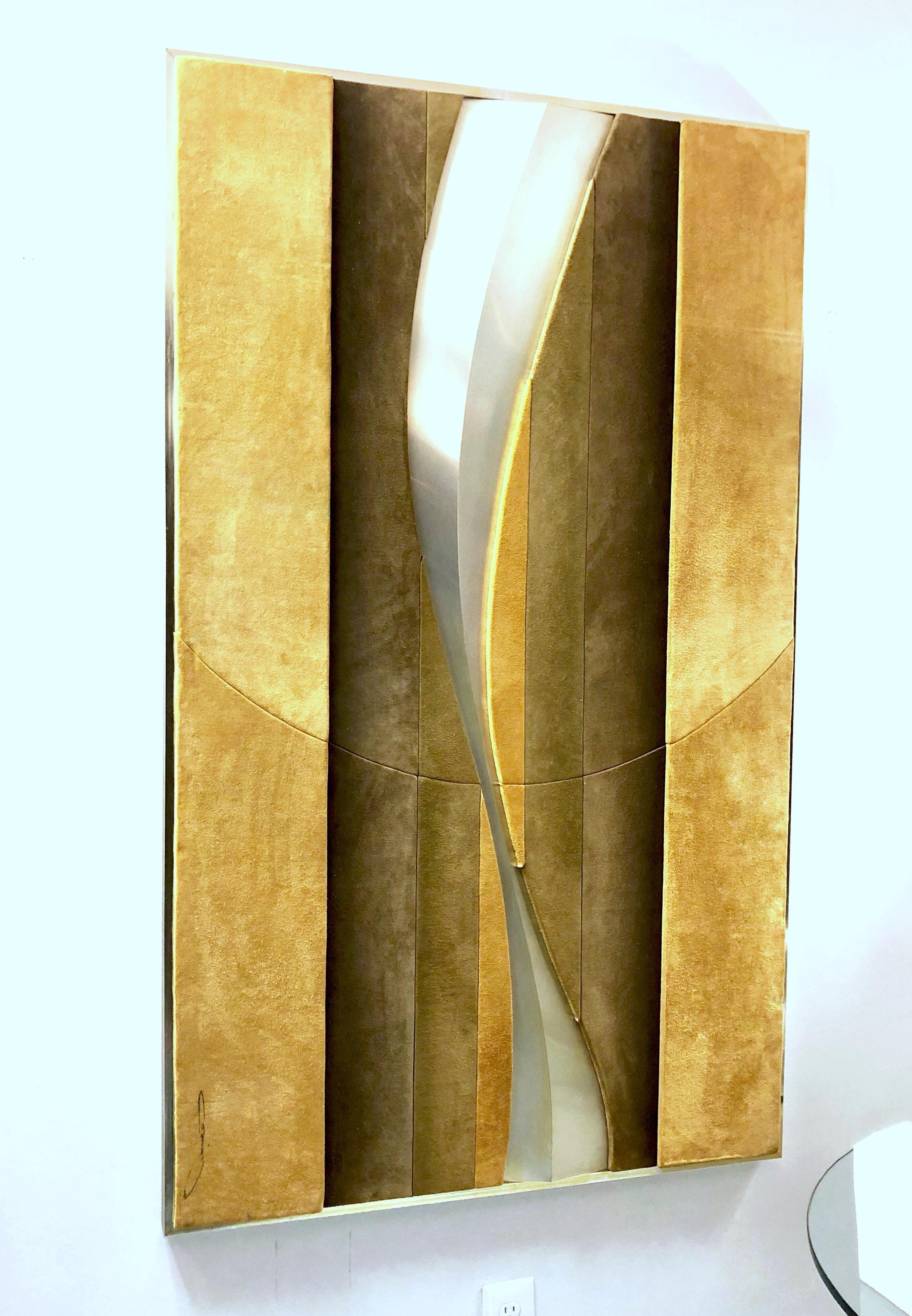 A very large sculptural wall art. Done in multiple pieces and tones of suede with a metal curving element arranged in an abstract design. Signed illegibly.