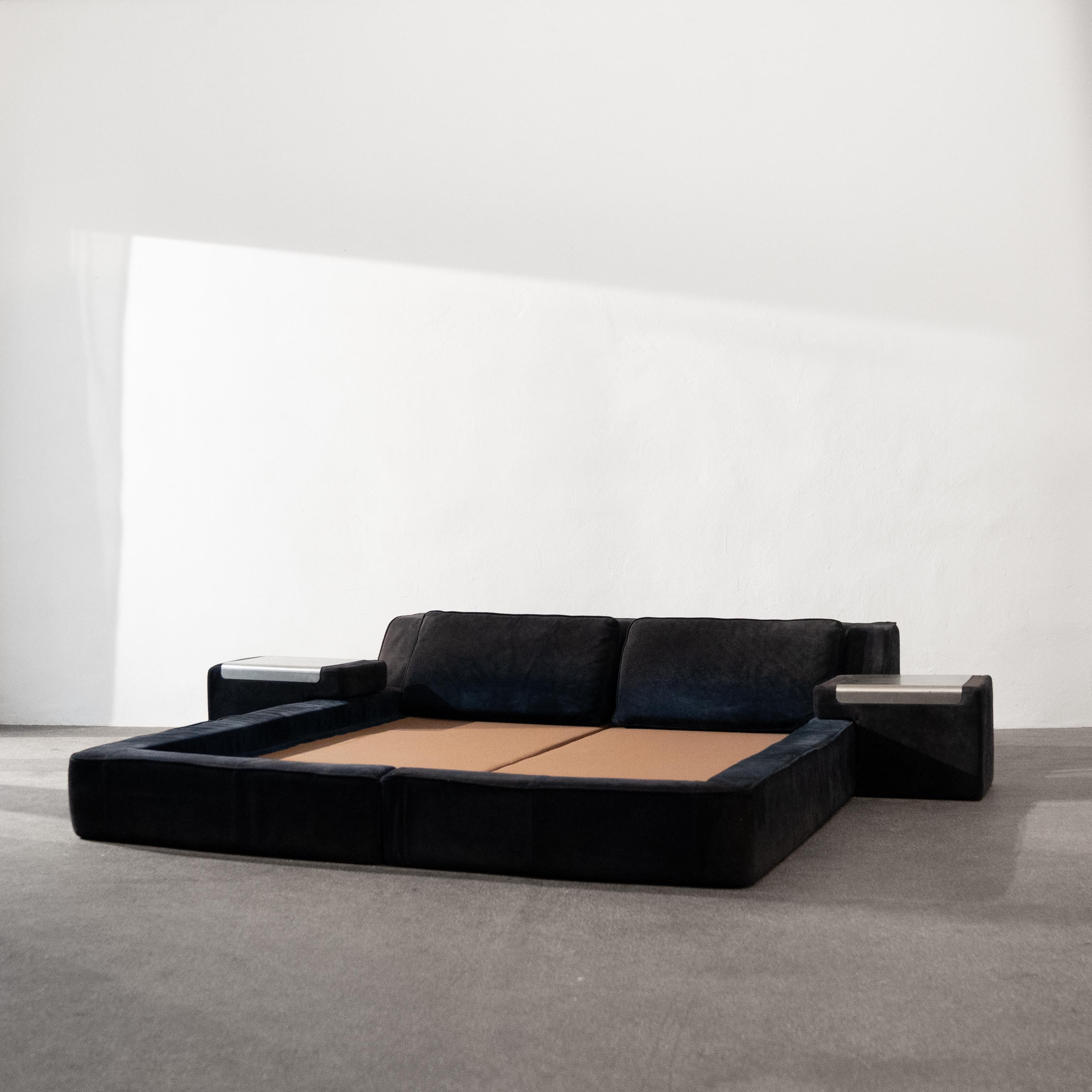 High-quality queen-size bed frame from Roche Bobois with matching bedside tables and pillows. The frame is made entirely of foam and covered in dark blue suede. This is a very rare model and is attributed to the Guido Faleschini design. 

The bed