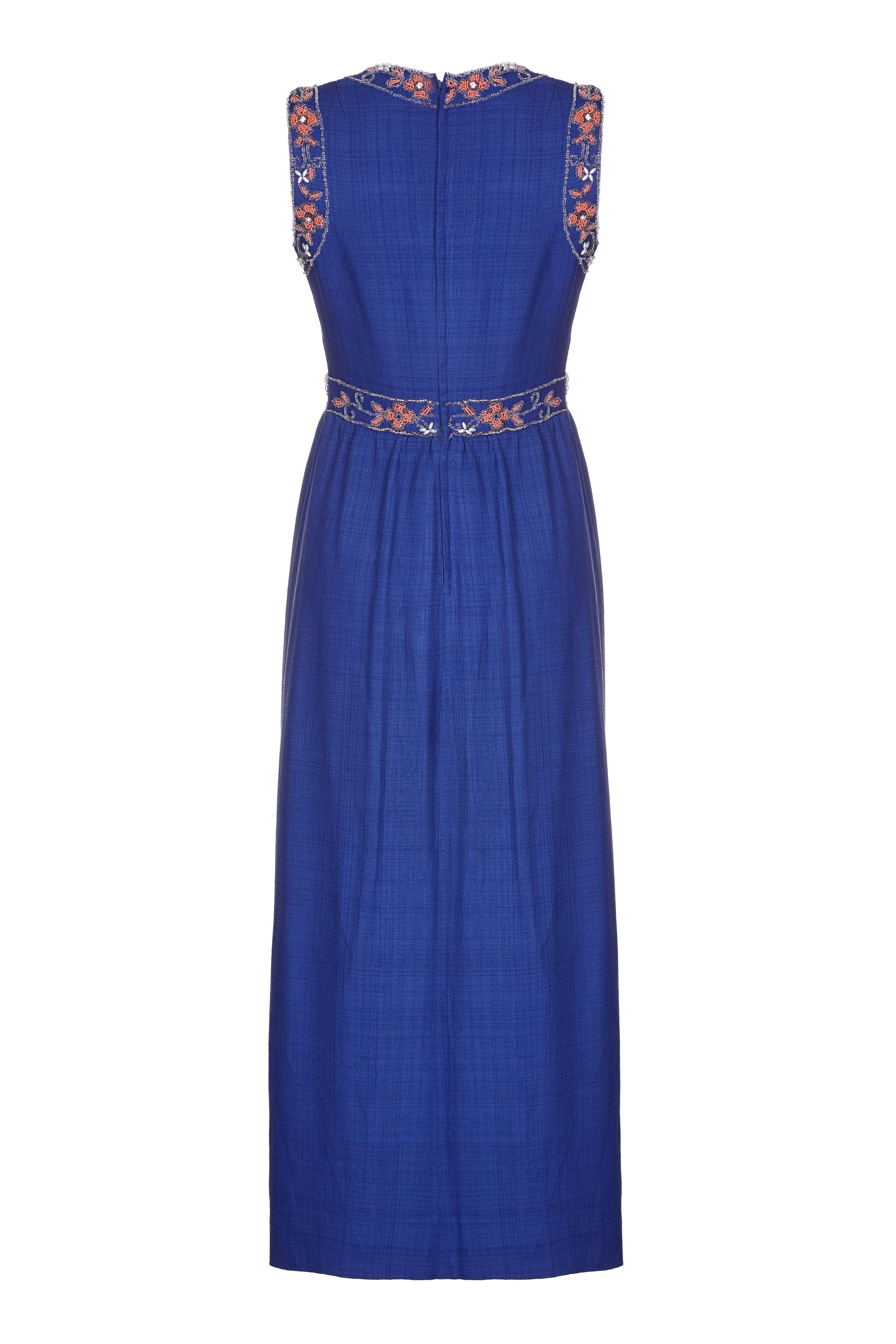 This elegant vintage 1970s Susan Small maxi dress in a cobalt blue silk and linen mix is of superb quality and features some exquisite embellishment on the bodice, neckline and arms. The delicate coral and crystal toned rocaille beading is