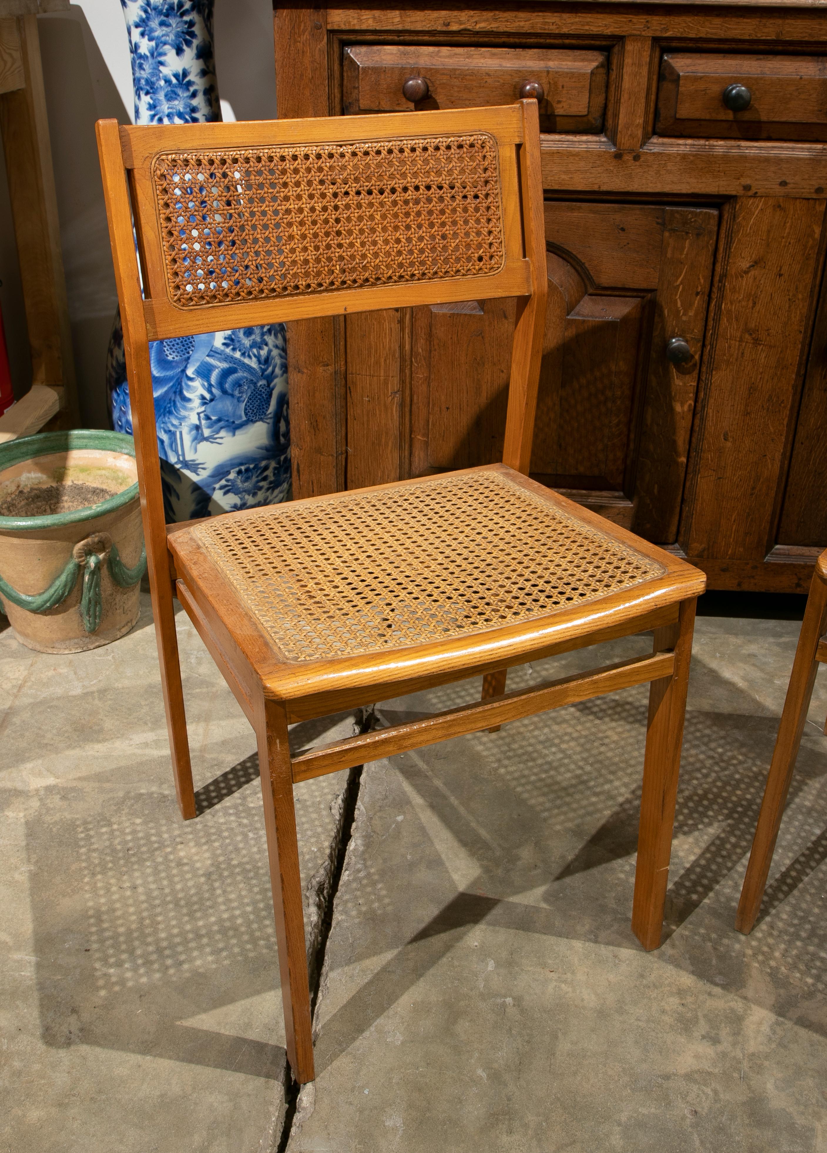 1970s Swedish pair of wooden chairs with wicker seat and back.