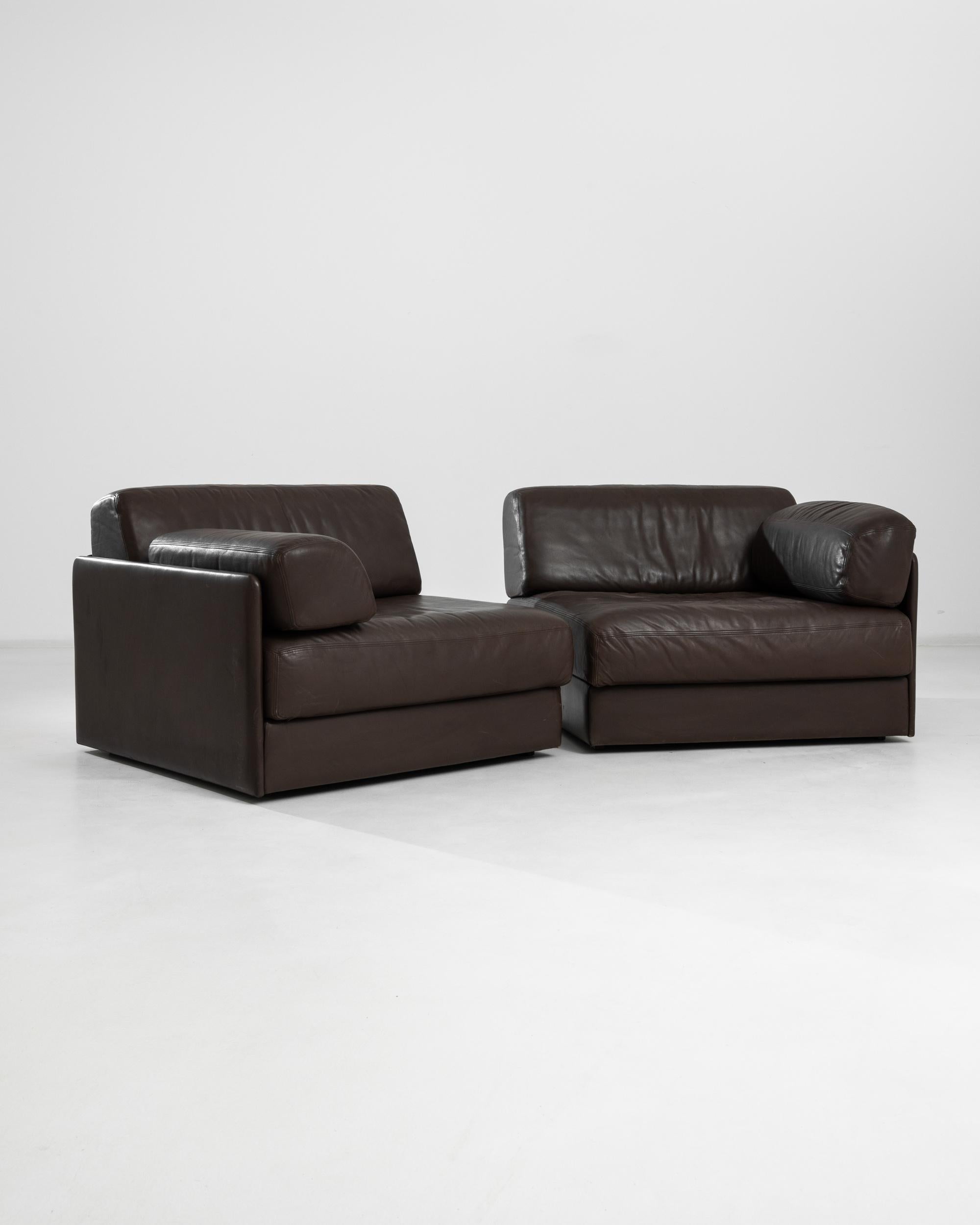 A vintage upholstered leather modular sofa made circa 1970 by the renown company De Sede, a Swiss manufacturer of exclusive furniture. A stunning symmetric two-piece sofa in a lush dark chocolate tone, allowing for versatility and playful changes of
