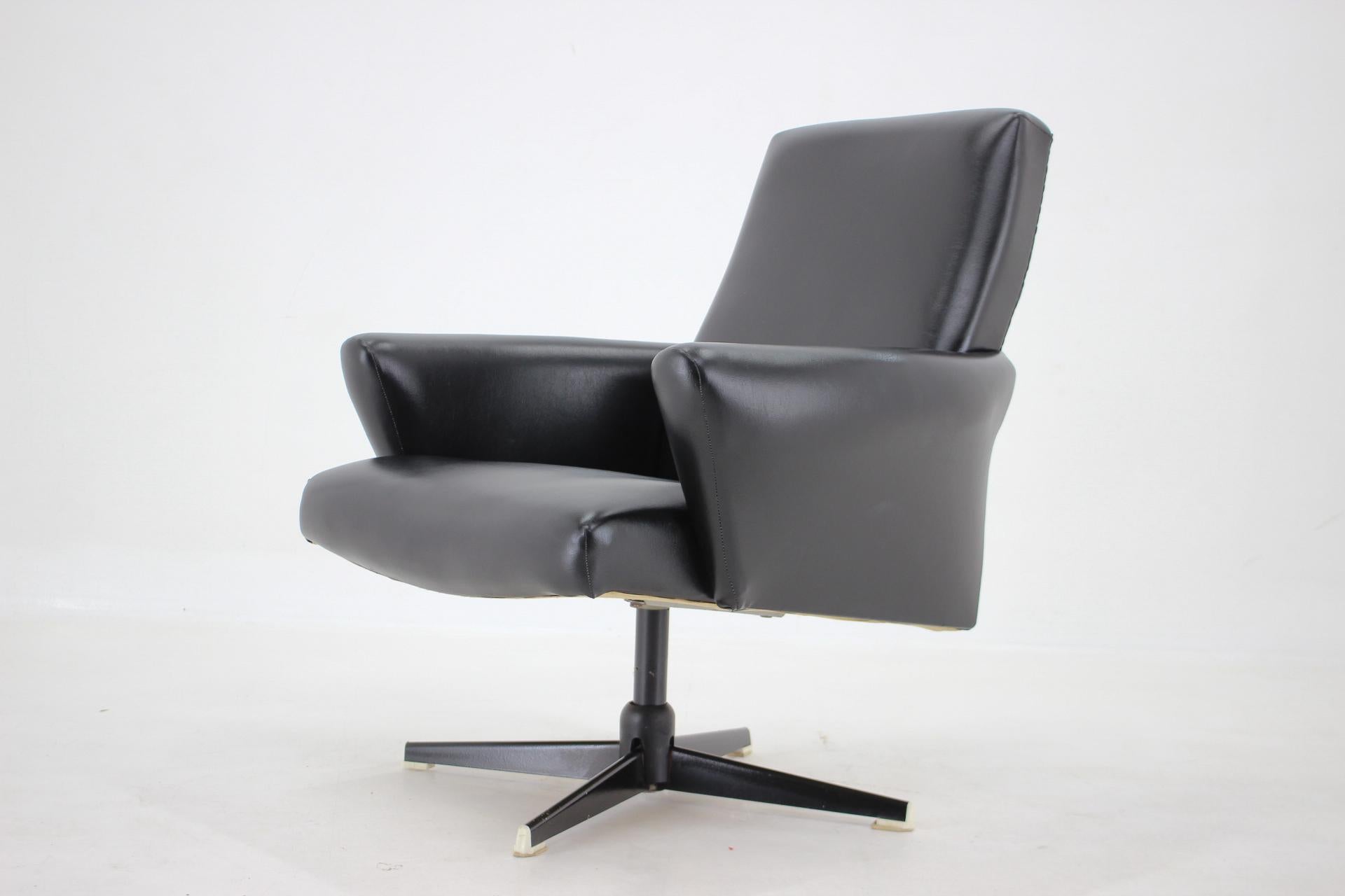Mid-century black leatherette swivel armchair produced in former Czechoslovakia in the 1970's.