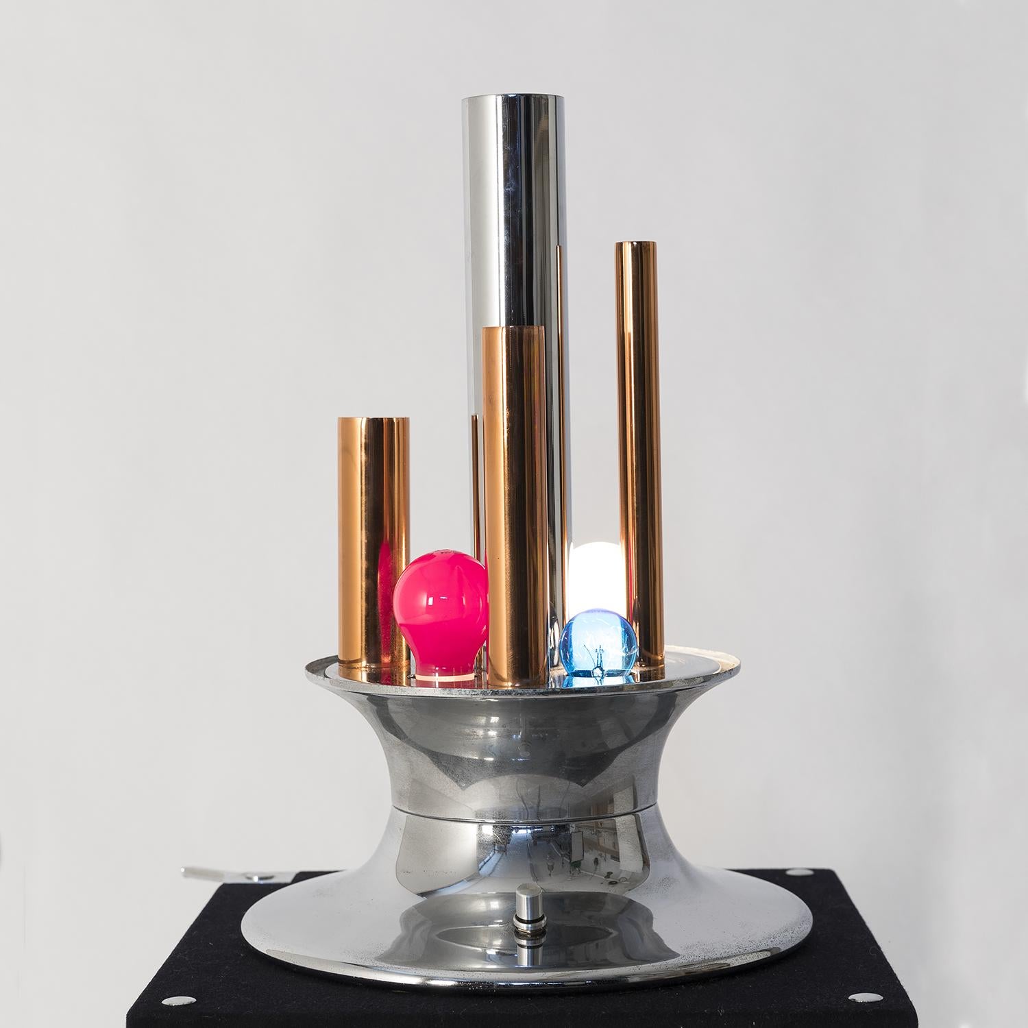 1970s table lamp manufactured by Selenova; brass and chrome columns and four colored bulbs (clear ones can fit as well) along with the shaded glass diffuser and the original working dimmer, create a pop light effect. Perfect condition and original