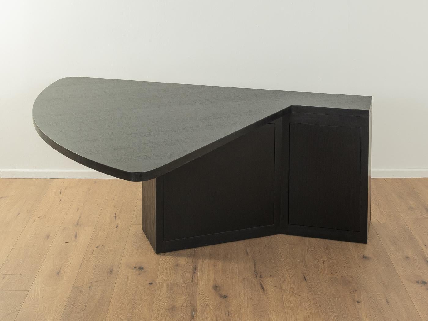Versatile table in Bauhaus design. Model M1 by Stefan Wewerka for Tecta. Draft from 1979. High-quality construction consisting of a base with two doors and two shelves and a table top in black lacquered ash veneer. The table can be used as a dining,