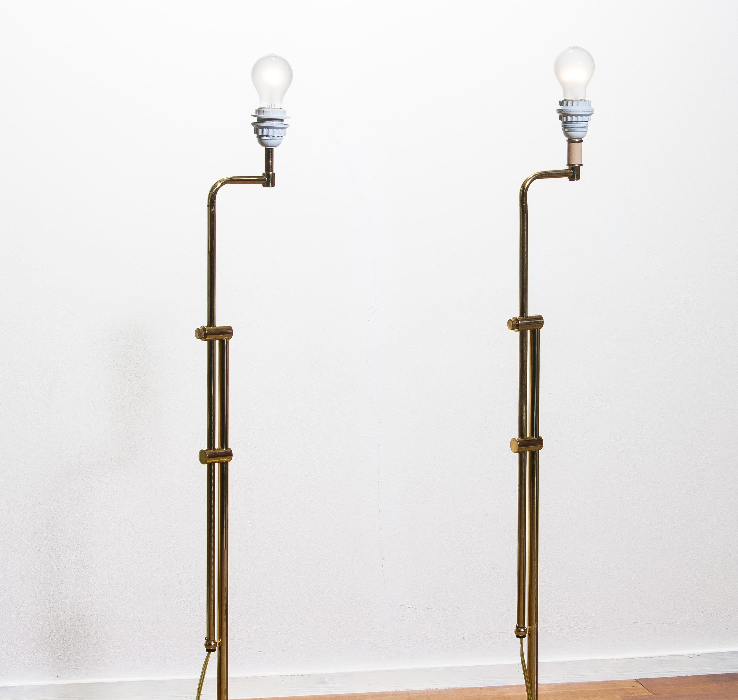 Beautiful set of two tall brass Hollywood Regency swing arm floor lamps. 
Both are newly wired and fittings. Size E27/28 for Europe and US.
Period 1970.
Measures: Height is adjustable from 110 - 155 cm / 43 - 61 inch.
ø floor stand: 23 cm / 9