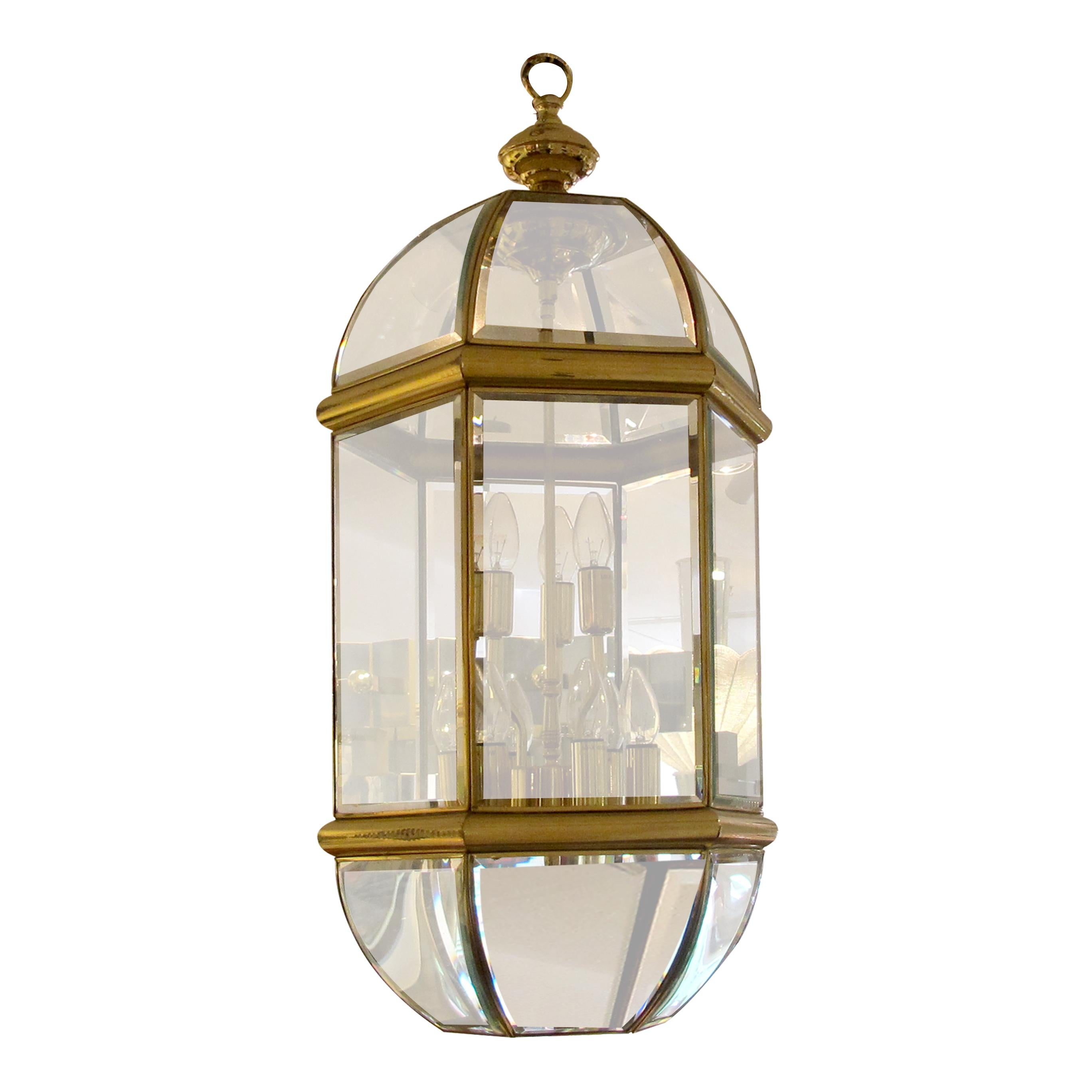 Elevate your space with the timeless charm of our Tall Brass Frame Lantern, a true masterpiece of craftsmanship and design. This lantern combines the warm radiance of brass with the captivating allure of curved bevelled glass panes, creating a