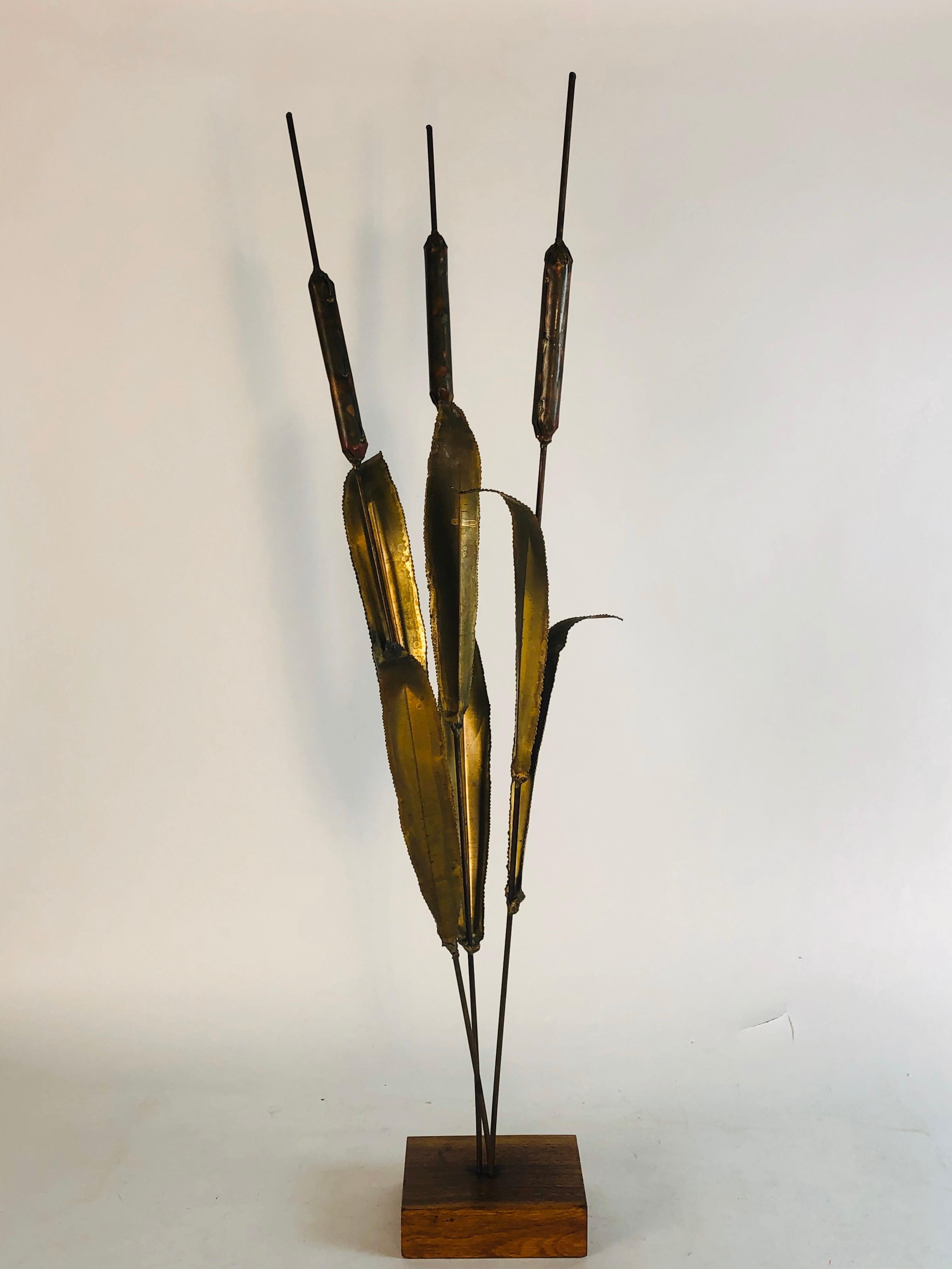 1970s tall table top metal Cat Tail sculpture on a wood block. Unsigned but beautifully crafted metal pieces.