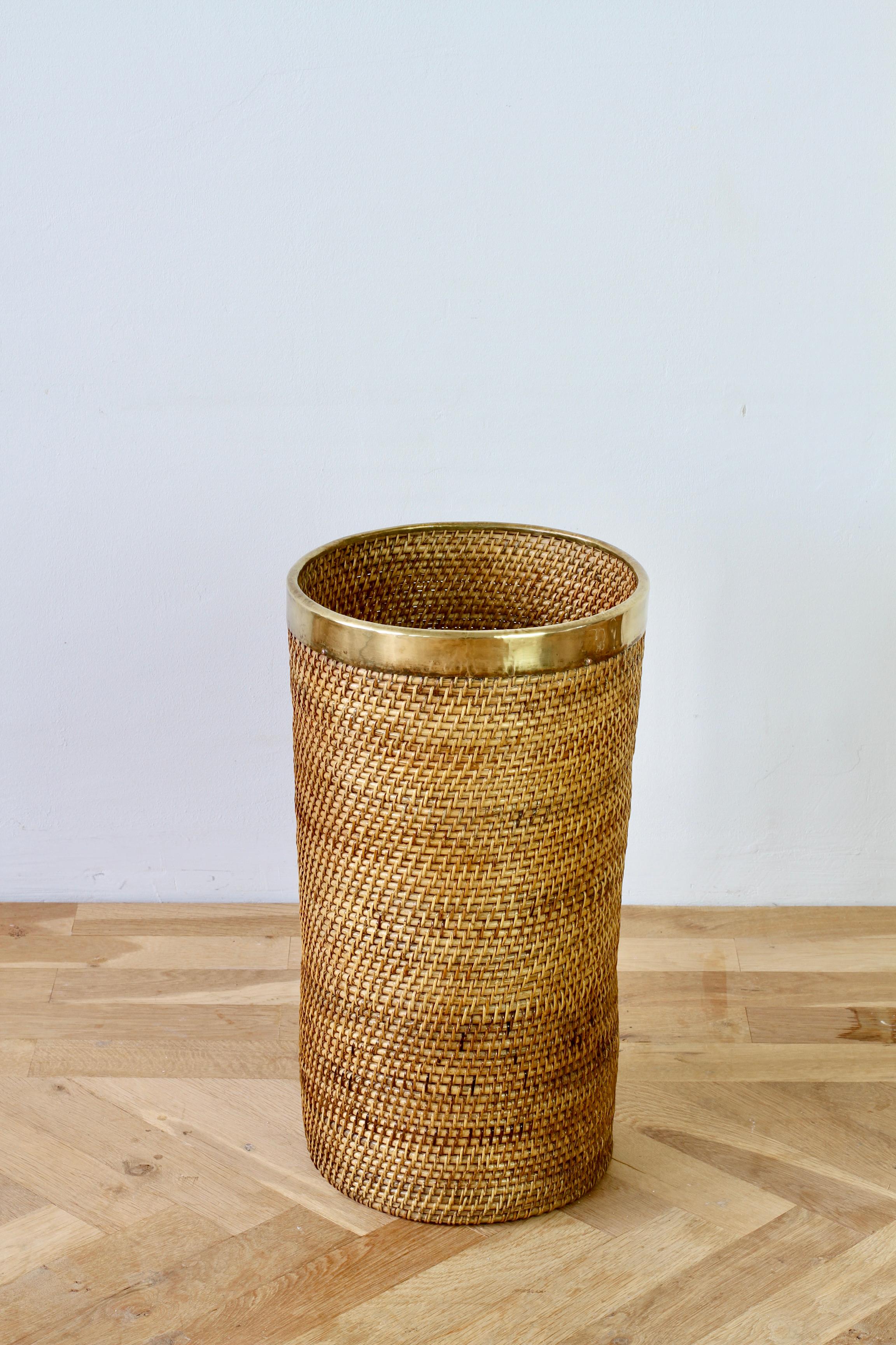 Tall and large mid-century Hollywood Regency umbrella stand / holder made in Italy, circa 1970s. Made of bamboo and rattan with a patinated brass metal rim, which finishes the piece perfectly. A must have for any Hollywood Regency enthusiast and