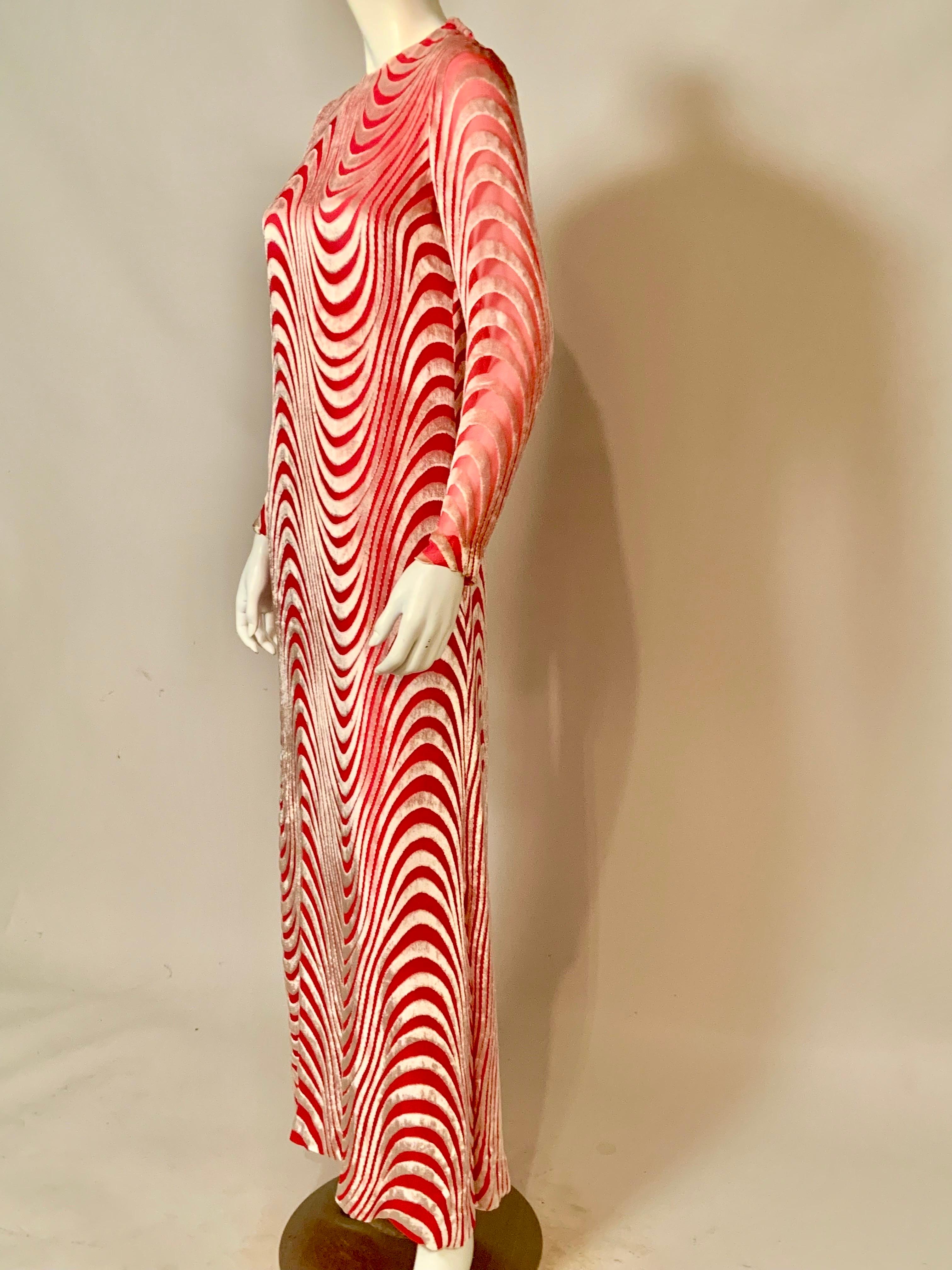 This lovely rose pink silk chiffon dress with undulating white devore velvet was designed in Paris in the 1970's by Tan Giudicelli and retailed by Giorgio of Beverly Hills.  The dress is composed of 2 layers of silk chiffon with a long matching