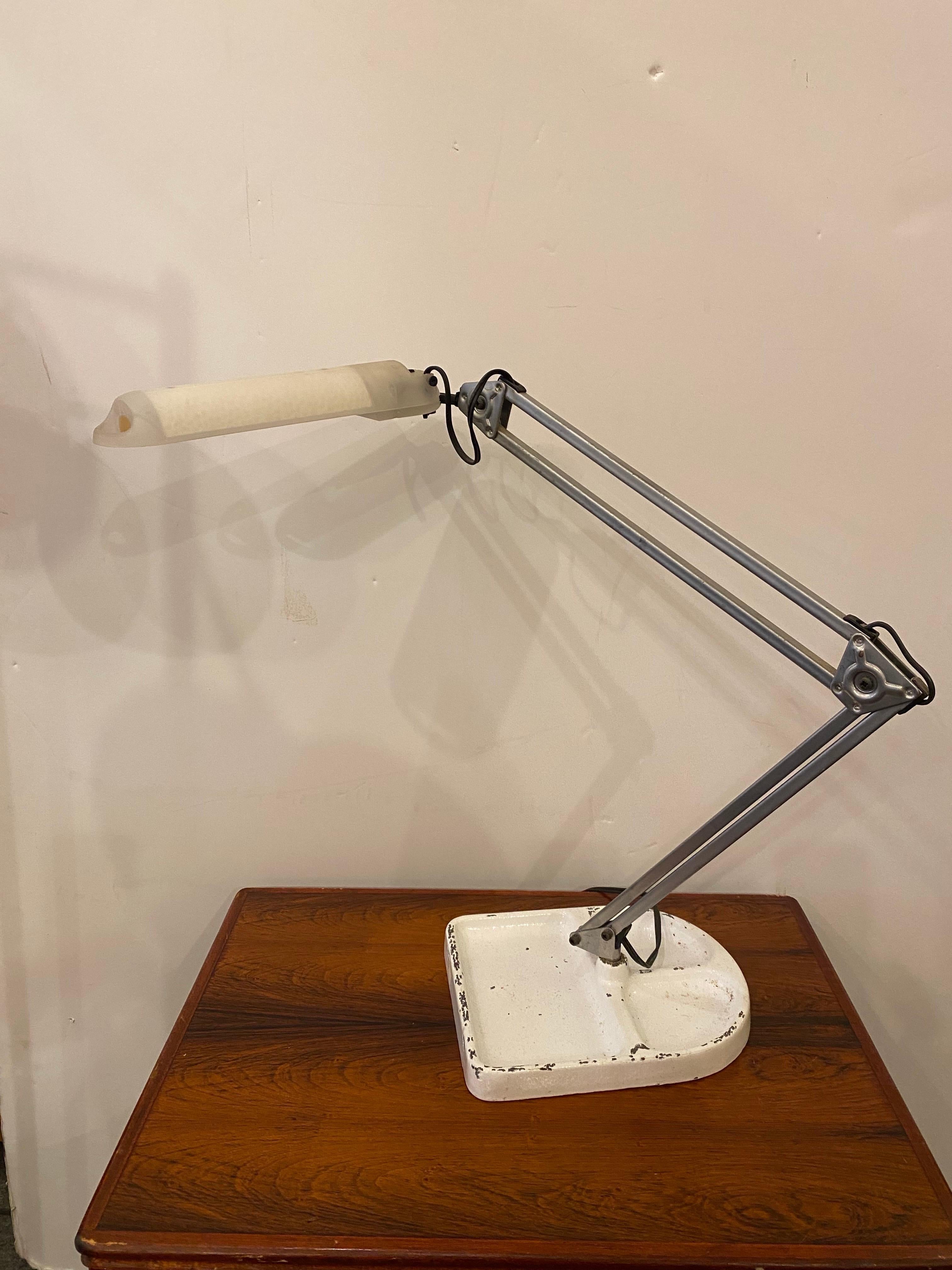 1970's Lival Finland Task Lamp, possibly from Ikea.  Heavy Iron base shows paint loss.  Metal pole of lamp sits in the base.  Lamp adjusts and allows you to place in the position that you desire.