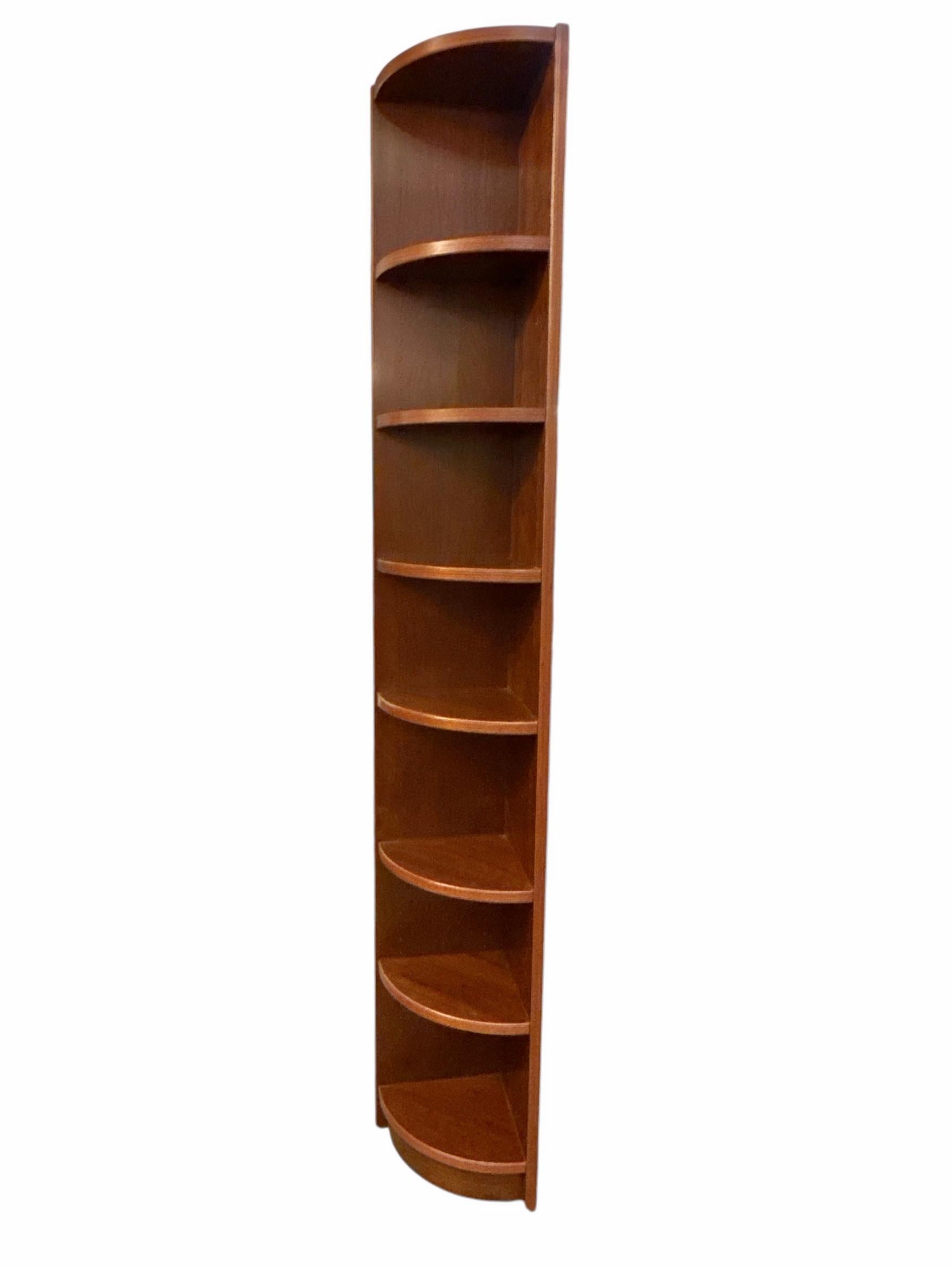 Introducing the 1970s Teak Danish Corner Display Tall Bookshelf, a stunning mid-century modern piece that seamlessly combines function and elegance. Crafted from high-quality teak wood, this timeless bookshelf boasts a rich, warm finish that