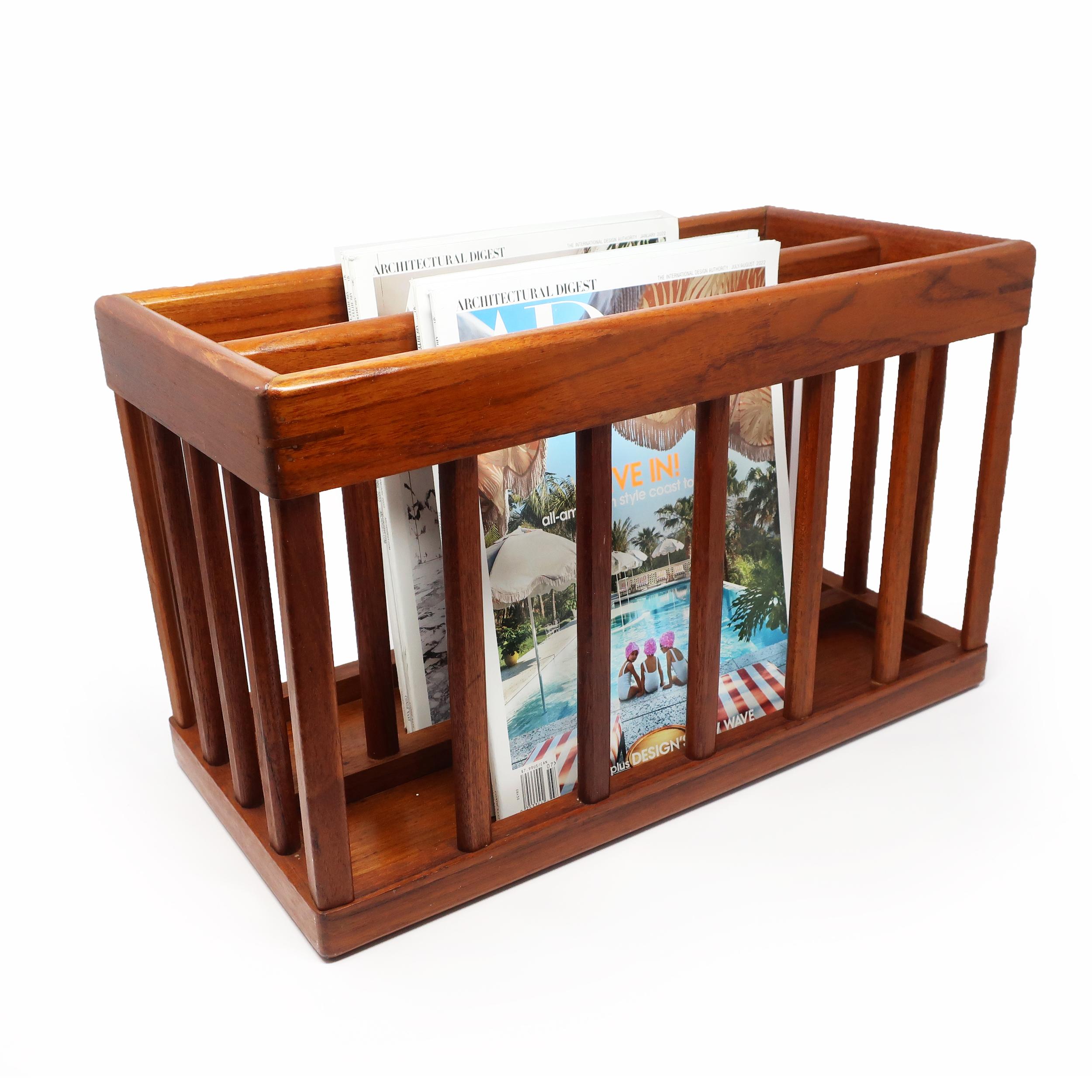 A gorgeous vintage mid-century modern teak magazine rack by Goodwood. Rectangular shape with vertical supports, two compartments, and a convenient carry handle. A timeless design that effortlessly blends with almost any décor style and is perfect